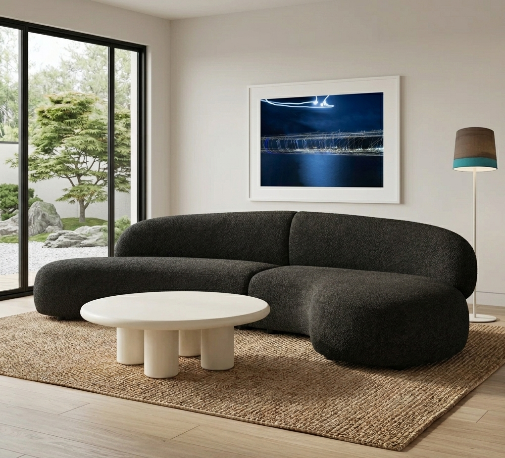 Architectural+living+room+with+the+Moritz+2-piece+curved+sectional+in+Licorice+Boucle%2C+ivory+Elephant+round+coffee+table%2C+Sisters+floor+lamp.png