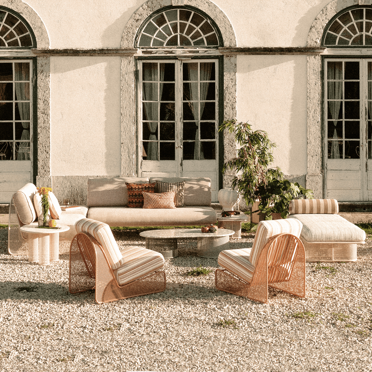 Outdoor furniture set with Riviera coffee table featuring green terrazzo top and metal base
