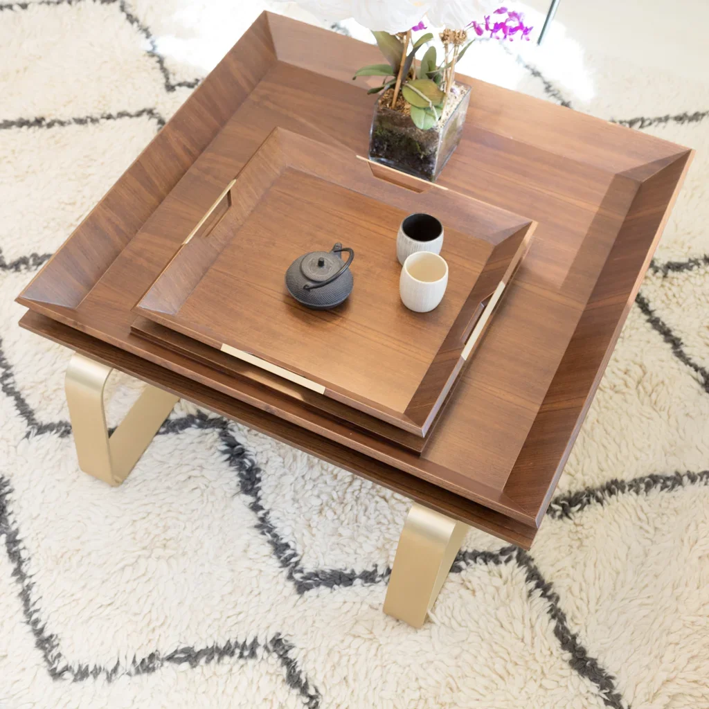 Dark wood coffee table with curved brass legs on every shag rug