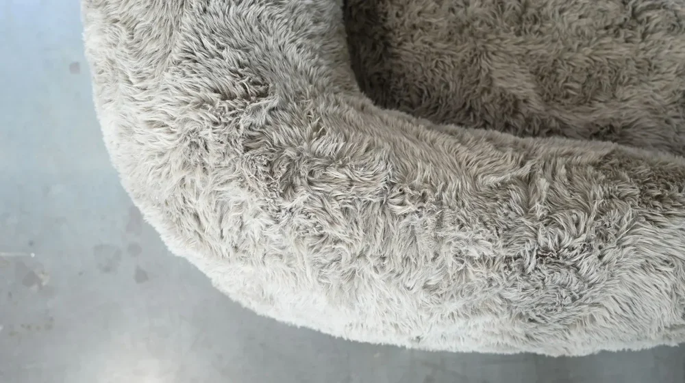 Close-up detail of the plush feather-filled cushion and premium fabric texture on the Saba chair.