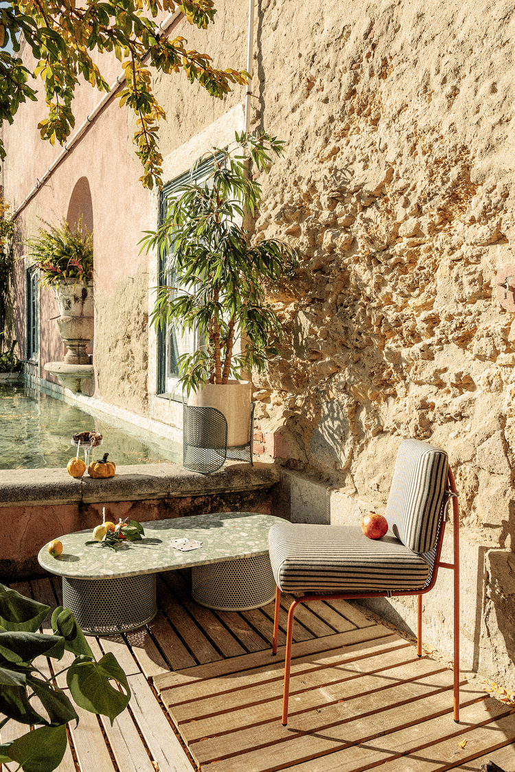 Riviera vase styled on a sunlit patio near water, showcasing a relaxed luxury outdoor lifestyle aesthetic.