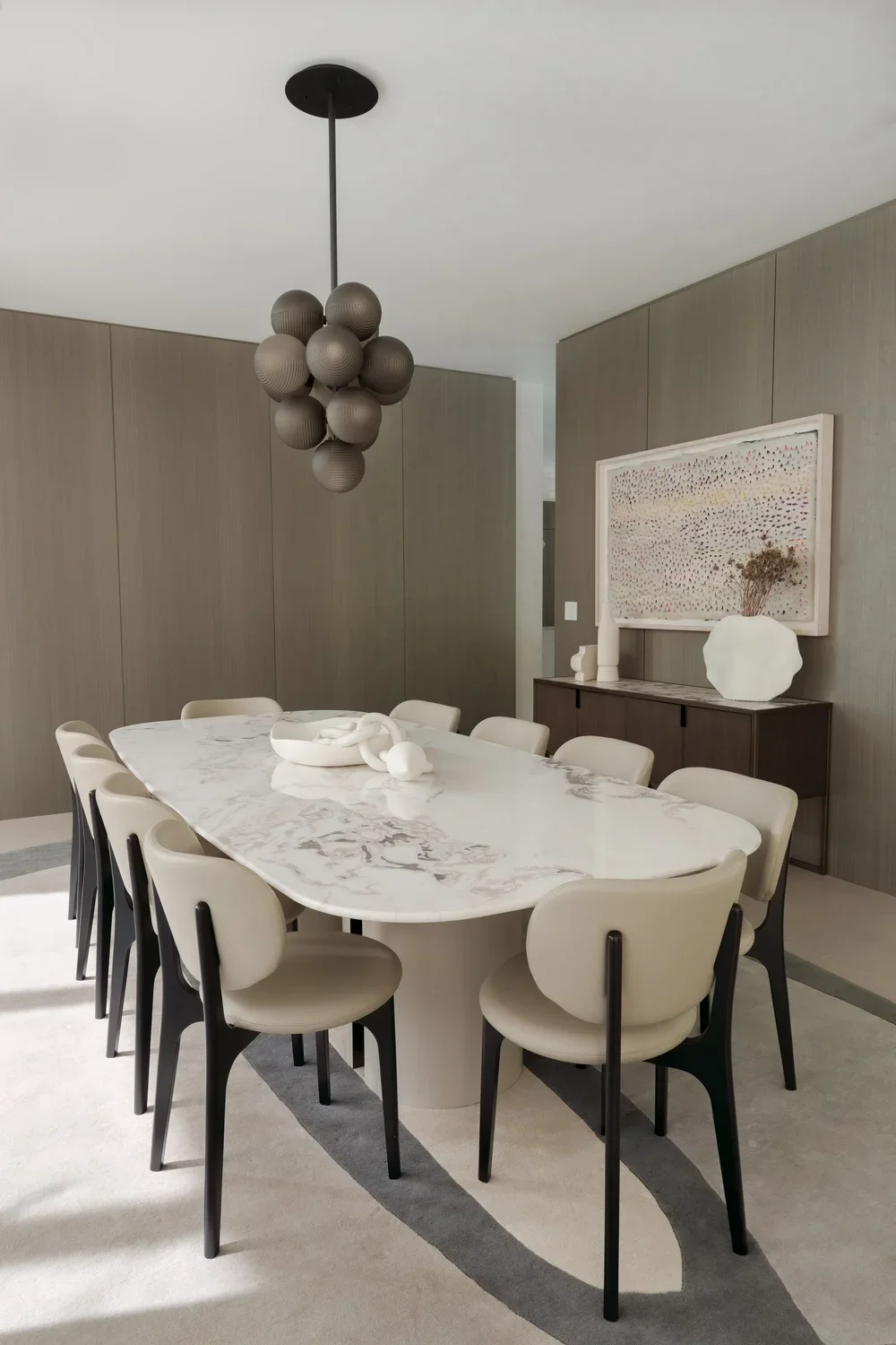 Modern Dining room design featuring the HORUS MARBLE DINING TABLE with a Calacatta Gold marble top and Lacquered base,  and the RICHMOND DINING CHAIRS - Marie Burgos Collection