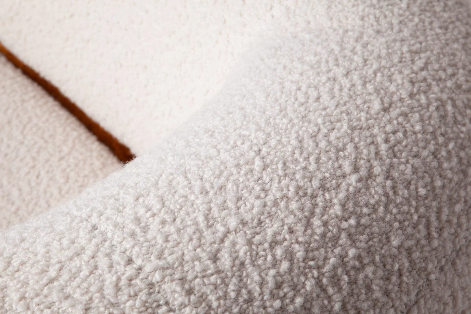 Close-up of Malibu Sofa in ivory bouclé fabric, showing the soft handwoven texture and natural fiber detail