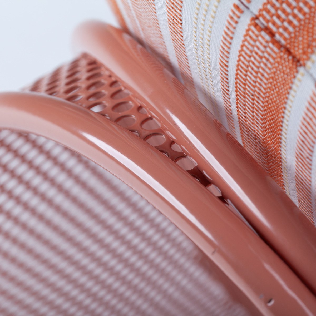 Close-up of the smooth, powder-coated metal frame and high-quality upholstery stitching on the Riviera Armchair.