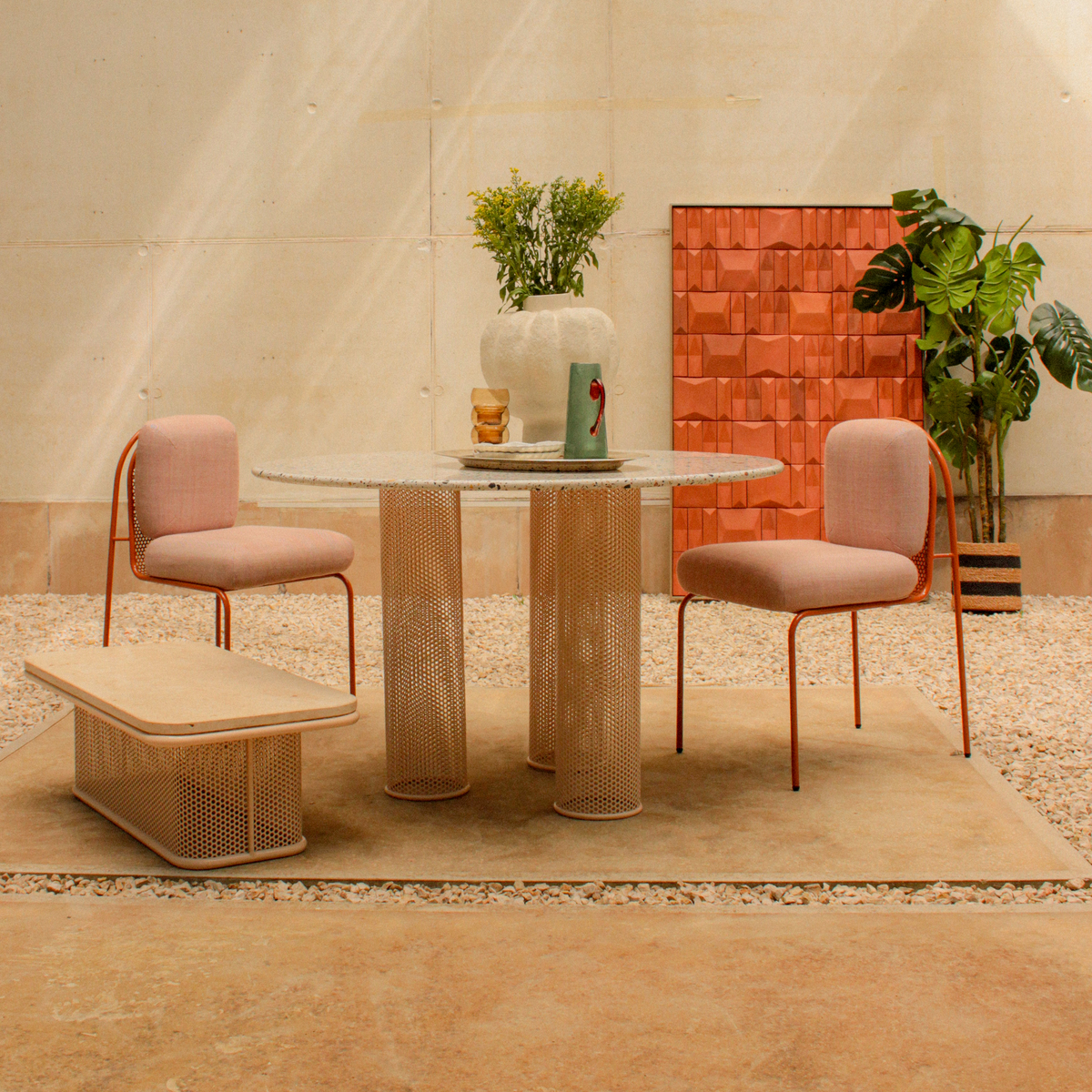 Outdoor dining setup with Riviera coffee table and matching perforated metal furniture