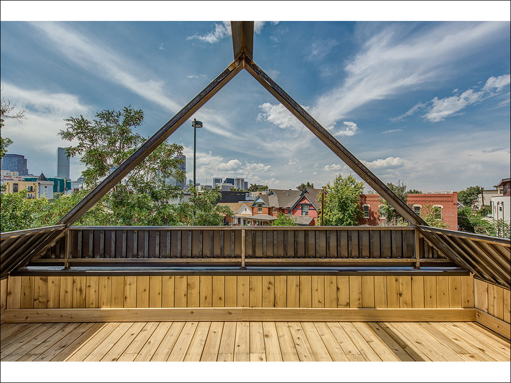 3rd floor deck with custom metal frame to allow for fabric shades in summer