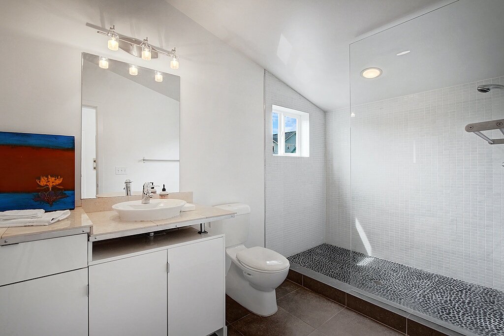  The master bath shower has a river rock floor, ceramic tile surround and radiant heated, limestone floors. 