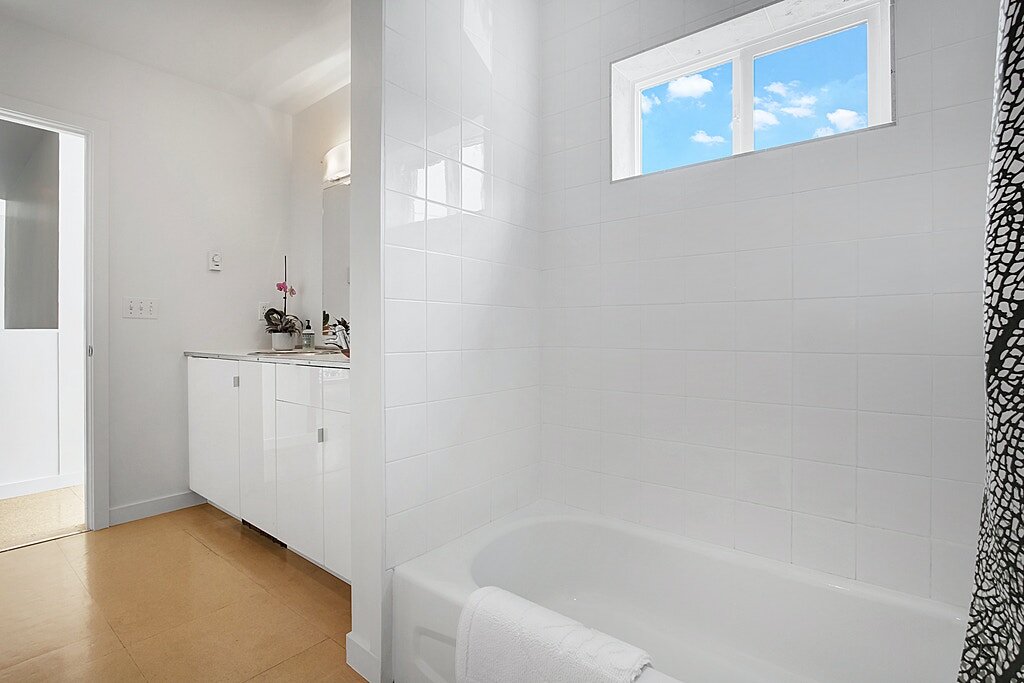  Cork floors and ceramic tile surround in the full bath. 