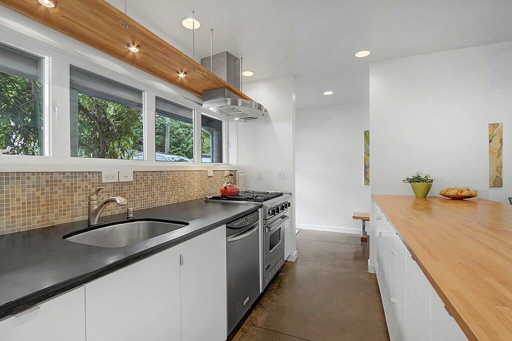  The kitchen has Paperstone counters and stainless appliances including a Viking gas range. 