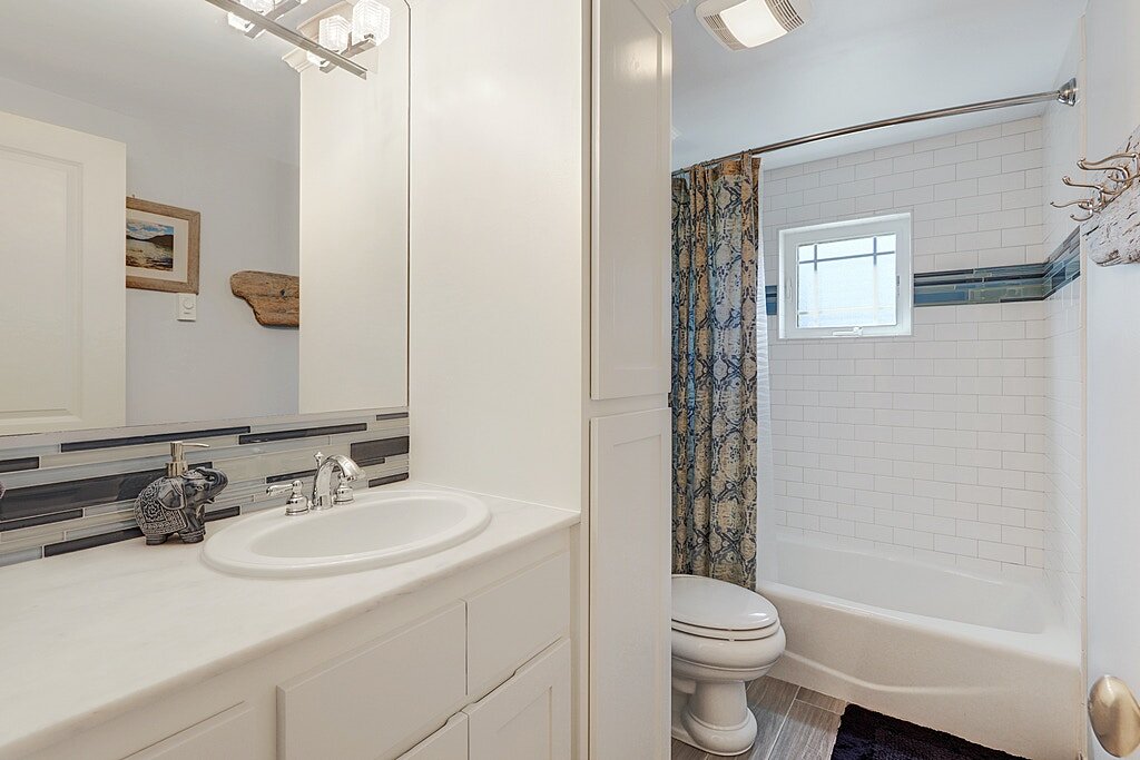  The master bathroom has been remodeled with new granite counters and ceramic tiled floors. There is plenty of linen storage as well. 