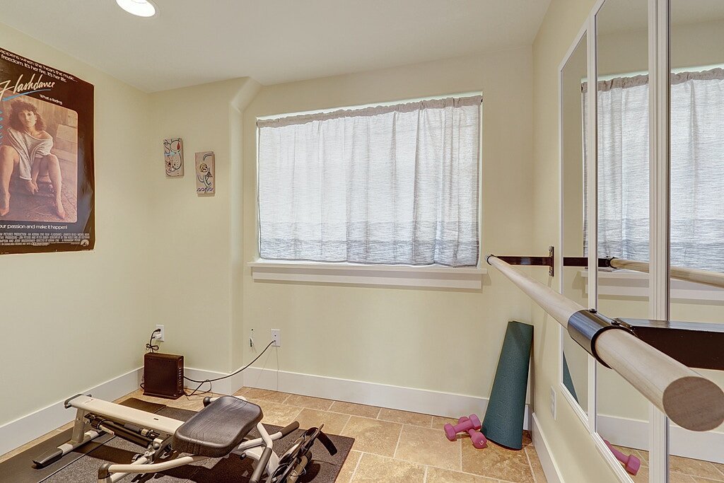 Did someone say ZOOM workout room? This downstairs bedroom has been fitted with a ballet bar and would fit your Peloton bike, rowing machine or elliptical. There is a large, under the stairs closet in this room as well. 