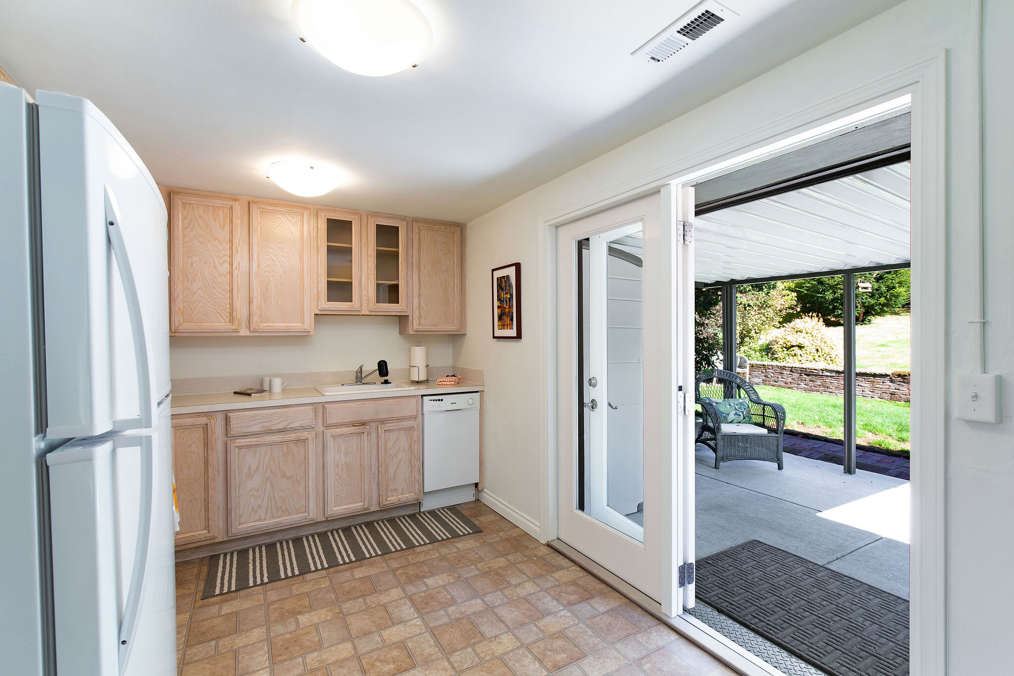  The kitchen has light and views from the yard with the french doors that open onto the covered patio. 