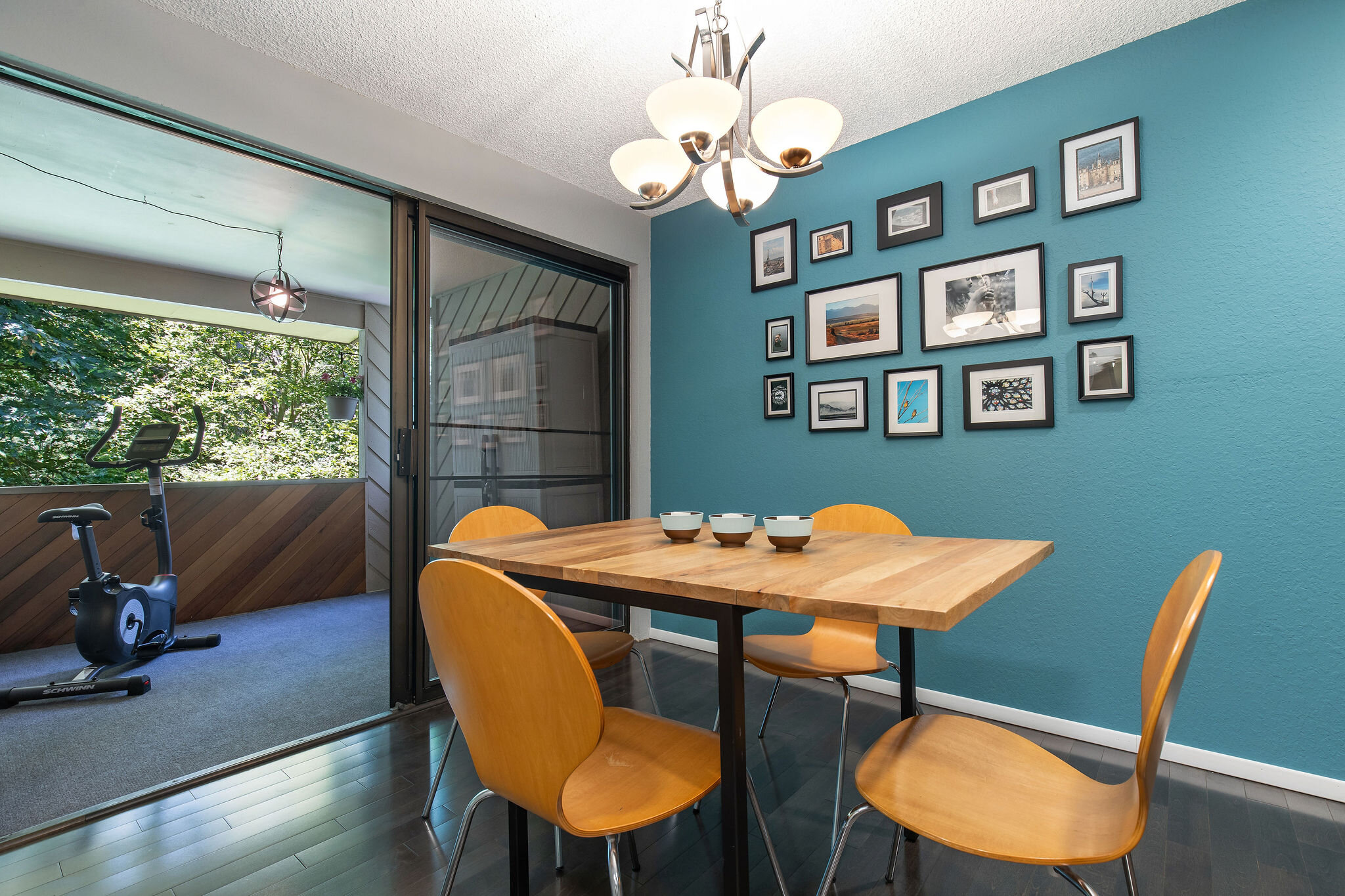  image description: interior of dining room with dining table and chairs and sliding glass door  