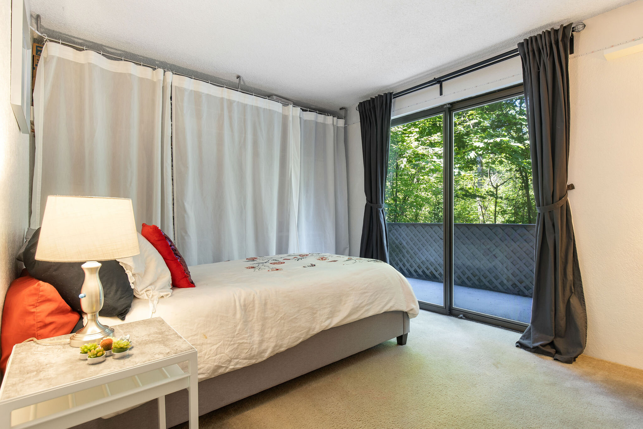  image description: interior of bedroom with twin bed, closet and sliding glass door 
