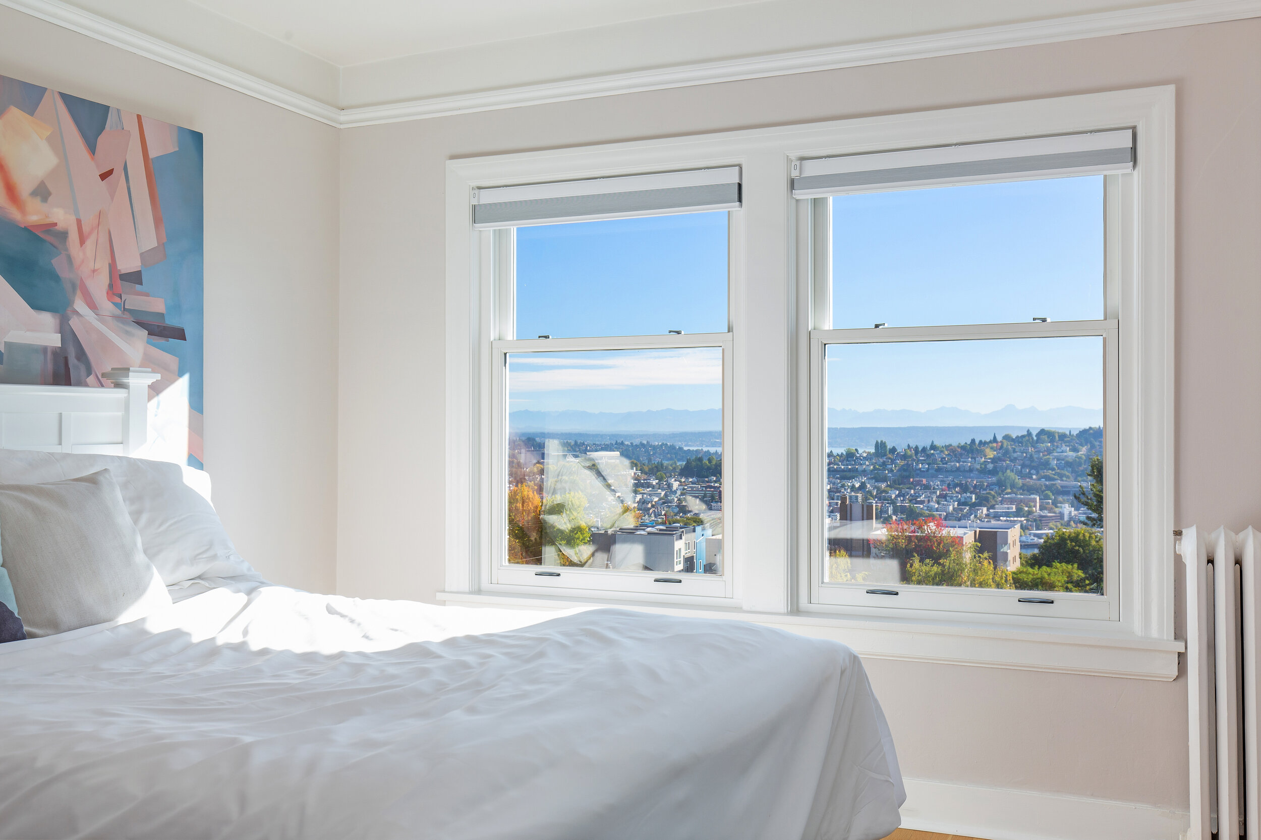  image description: interior bedroom with queen bed, and windows 