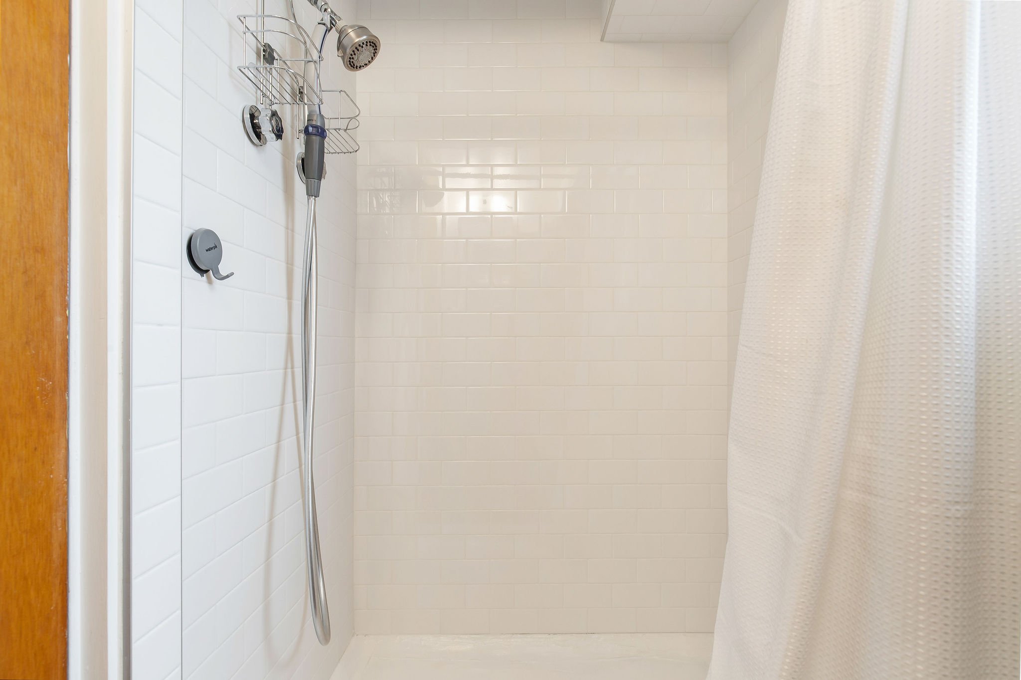  image description: interior of bathroom with tub and shower combo 