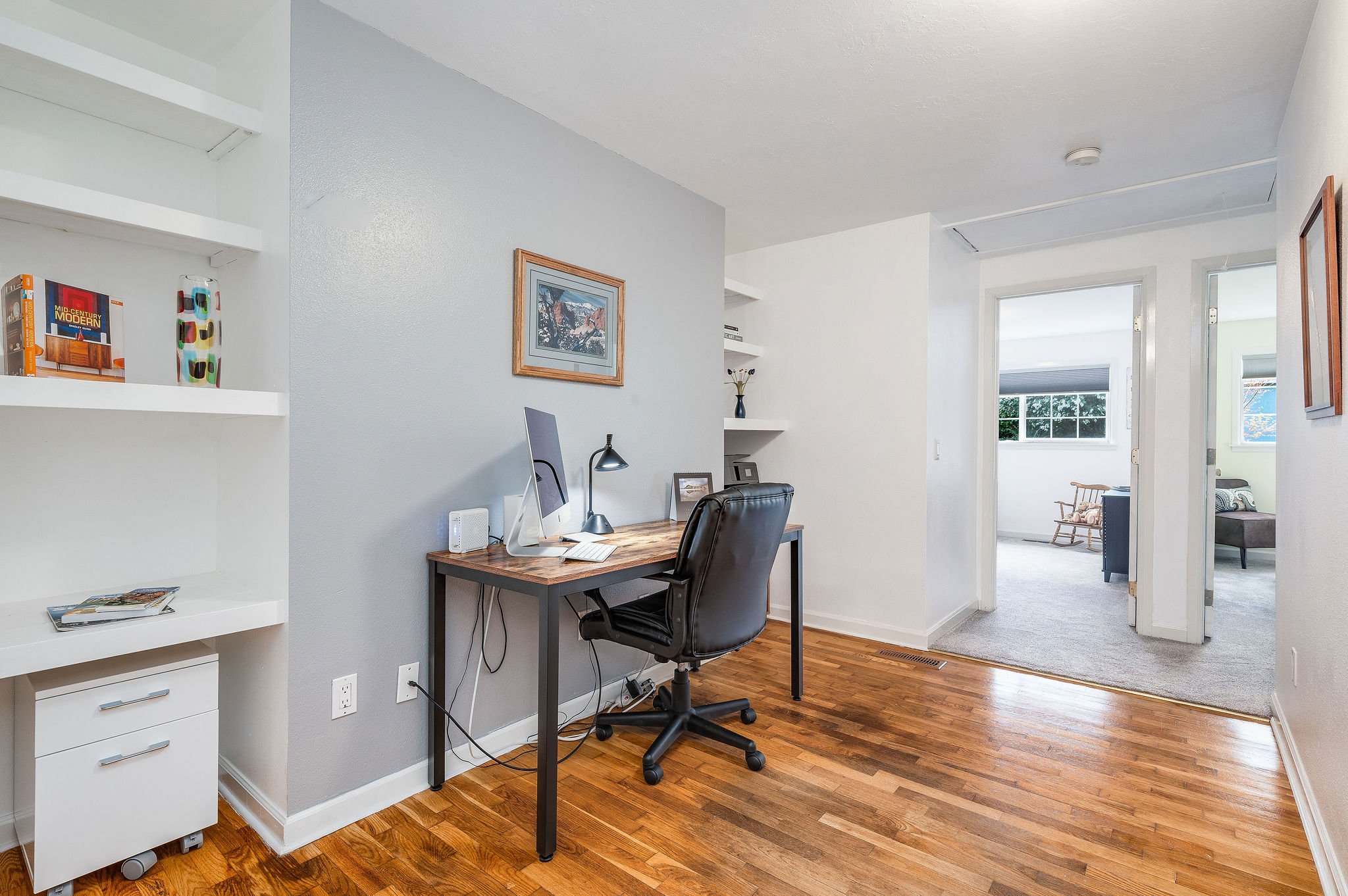 Dedicated office space with built-in shelves and a full-sized coat closet.