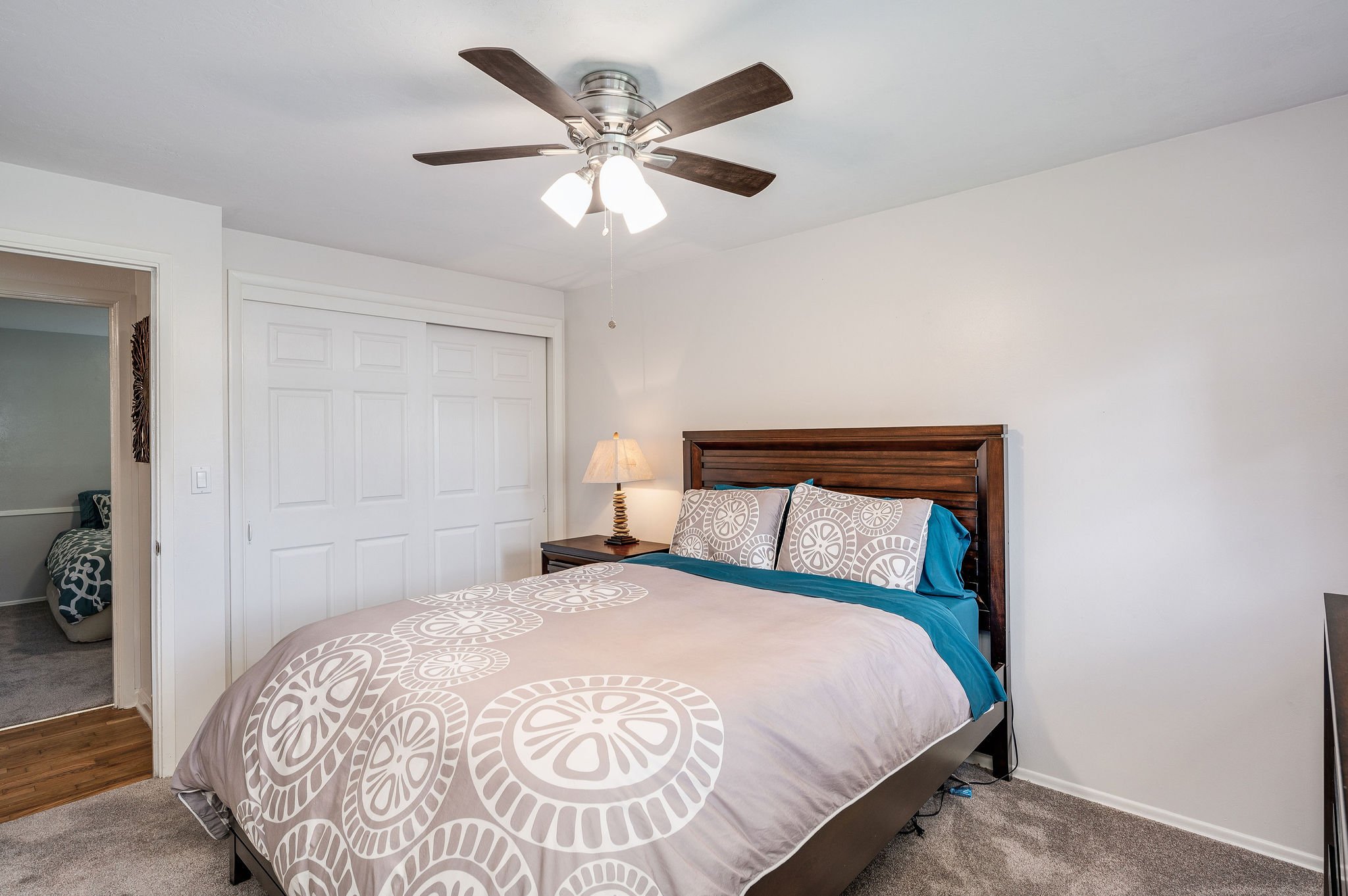  image description: interior of bedroom with king bed, and closet 