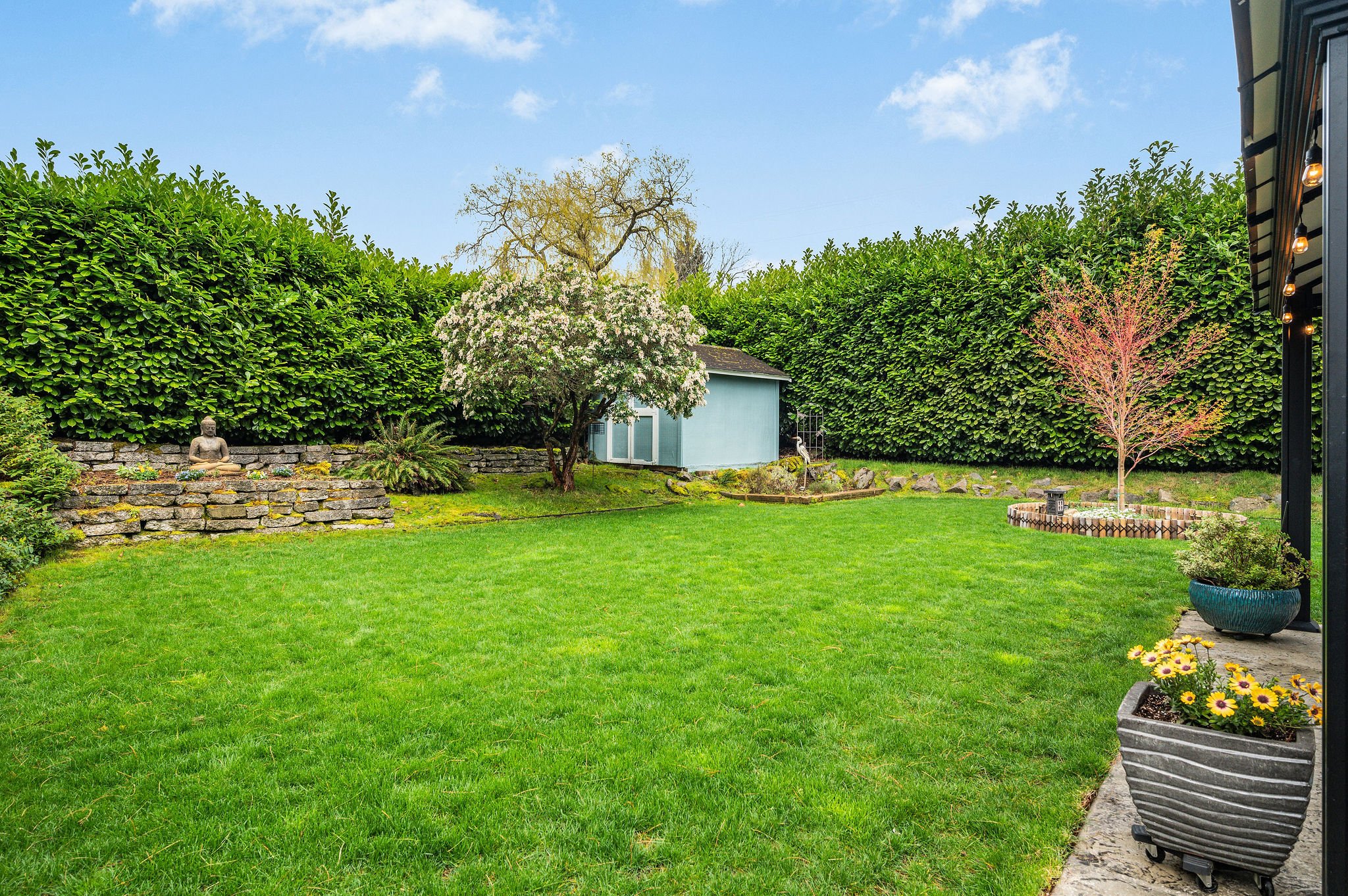 The yard was sodded and landscaped in 2018. A large hedge makes it feel very private. 