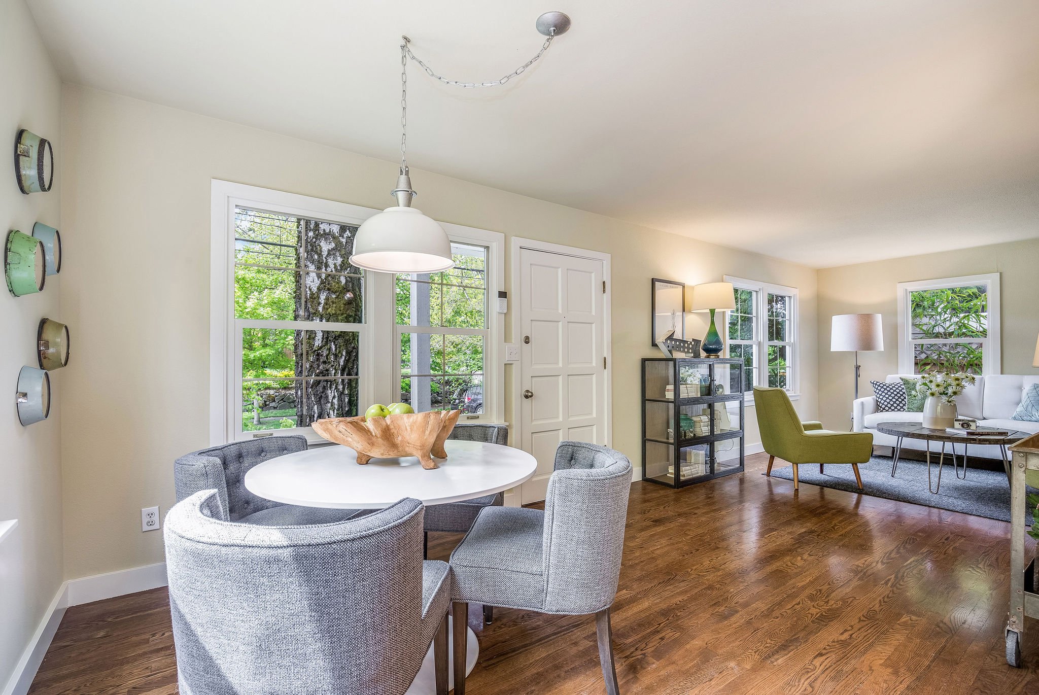  image description: interior dining room with 2 double windows, sliding glass door, hardwoods, and dining room table and chairs 