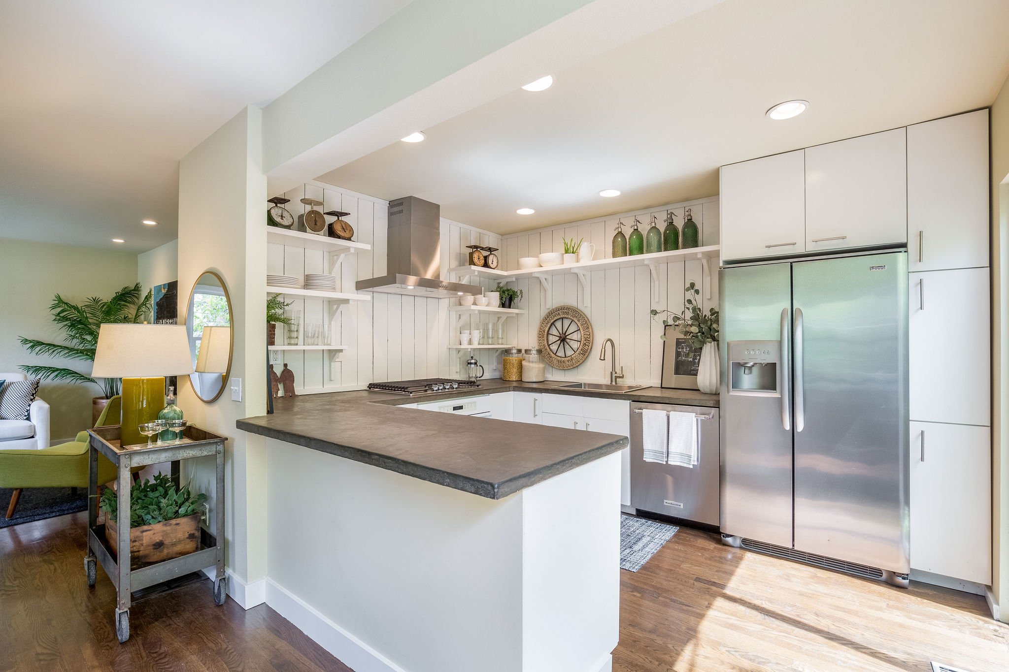  image description: interior kitchen with connected island, hardwoods and brown countertops 