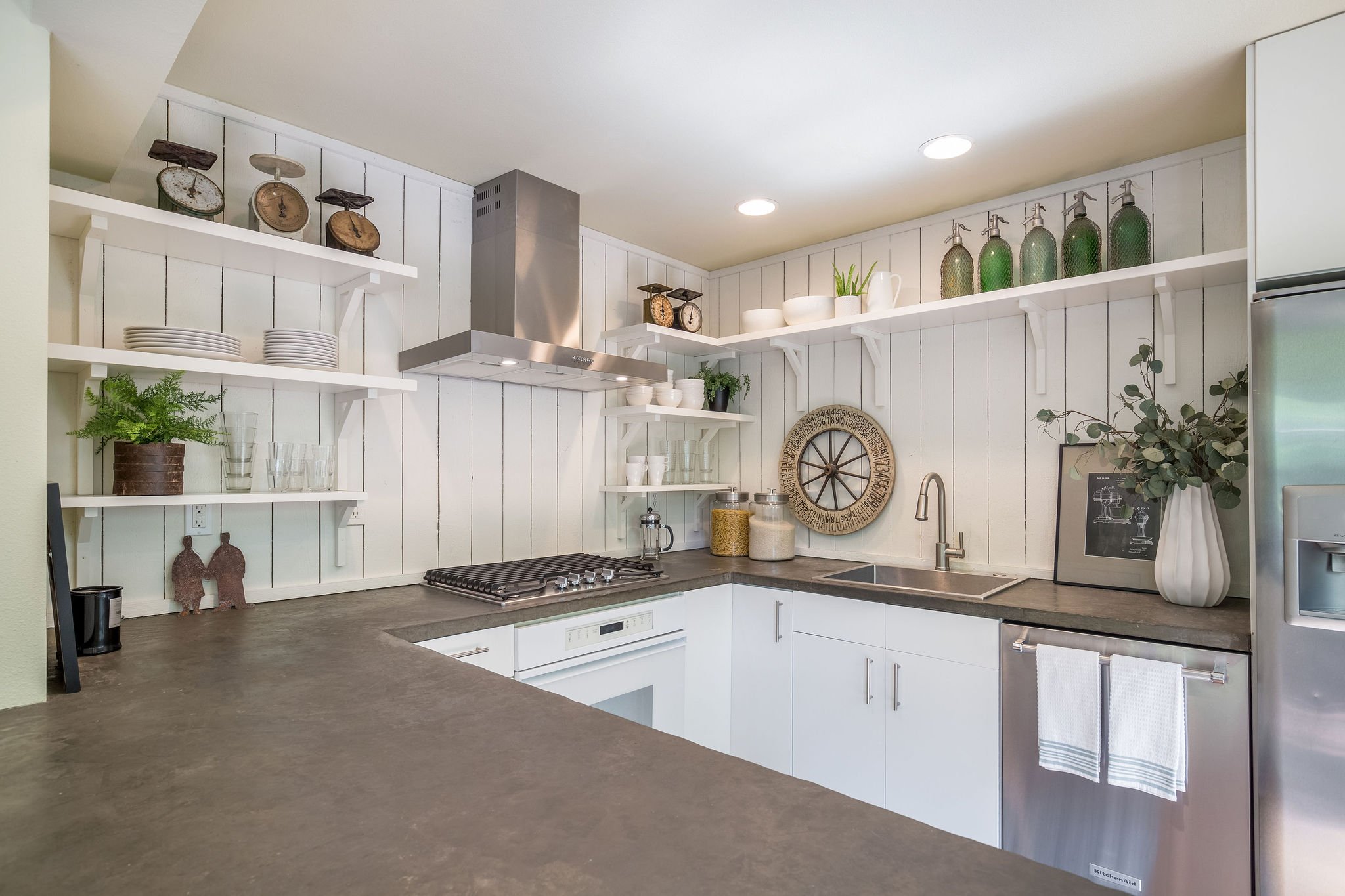  image description: interior kitchen with connected island, hardwoods and brown countertops 