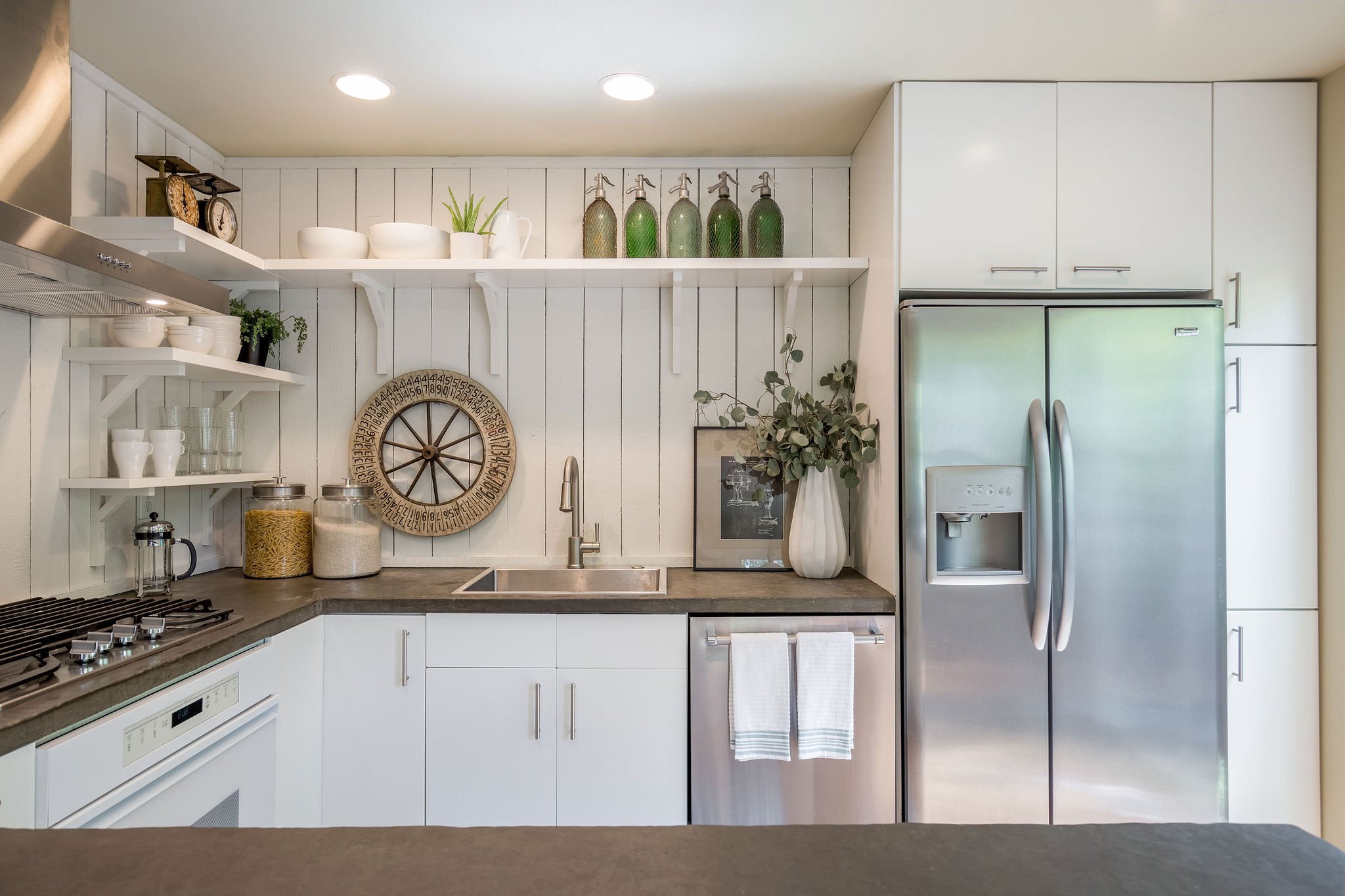  image description: interior kitchen with connected island, hardwoods and brown countertops 