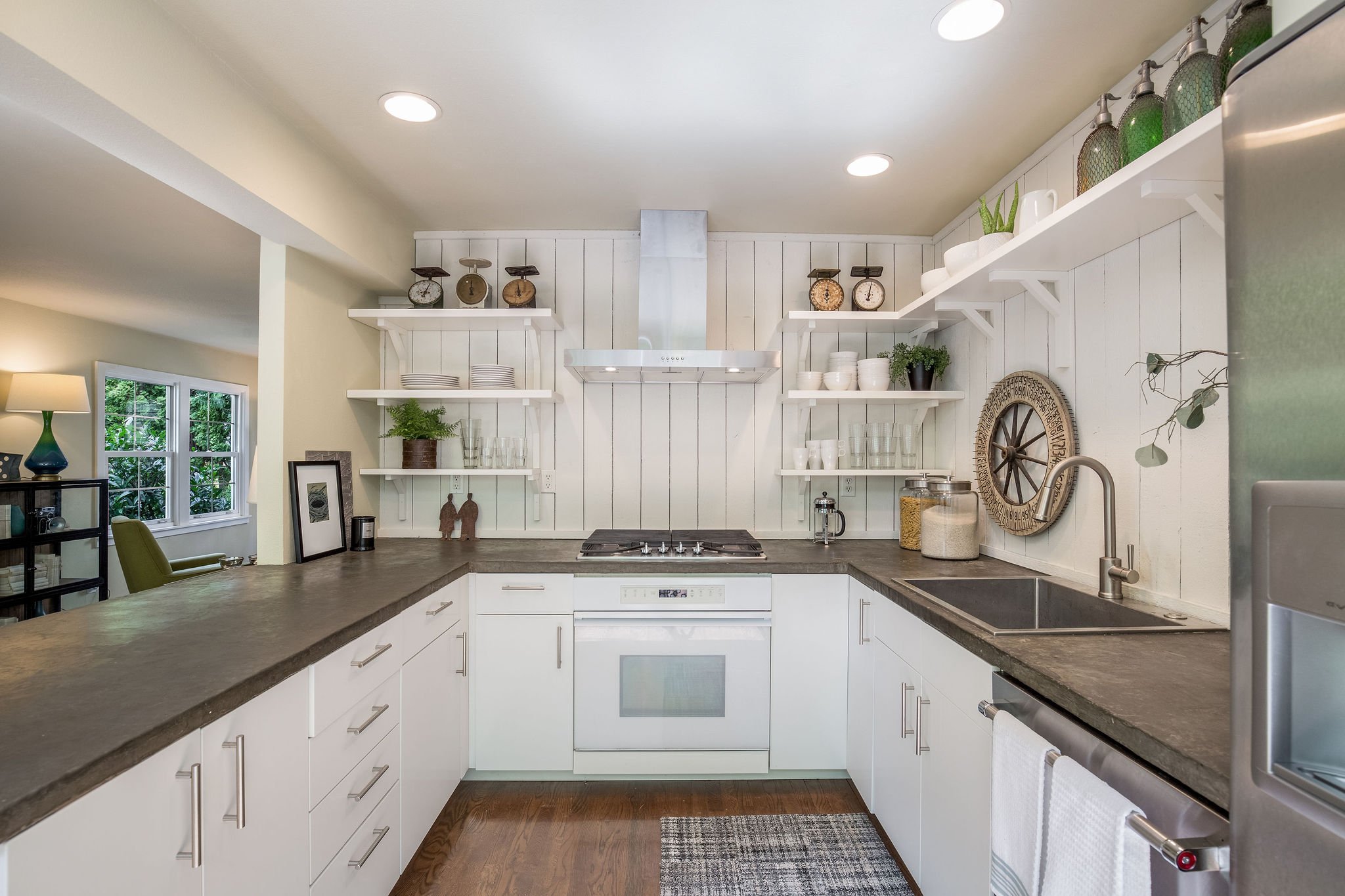  image description: interior kitchen with connected island, hardwoods and brown countertops 