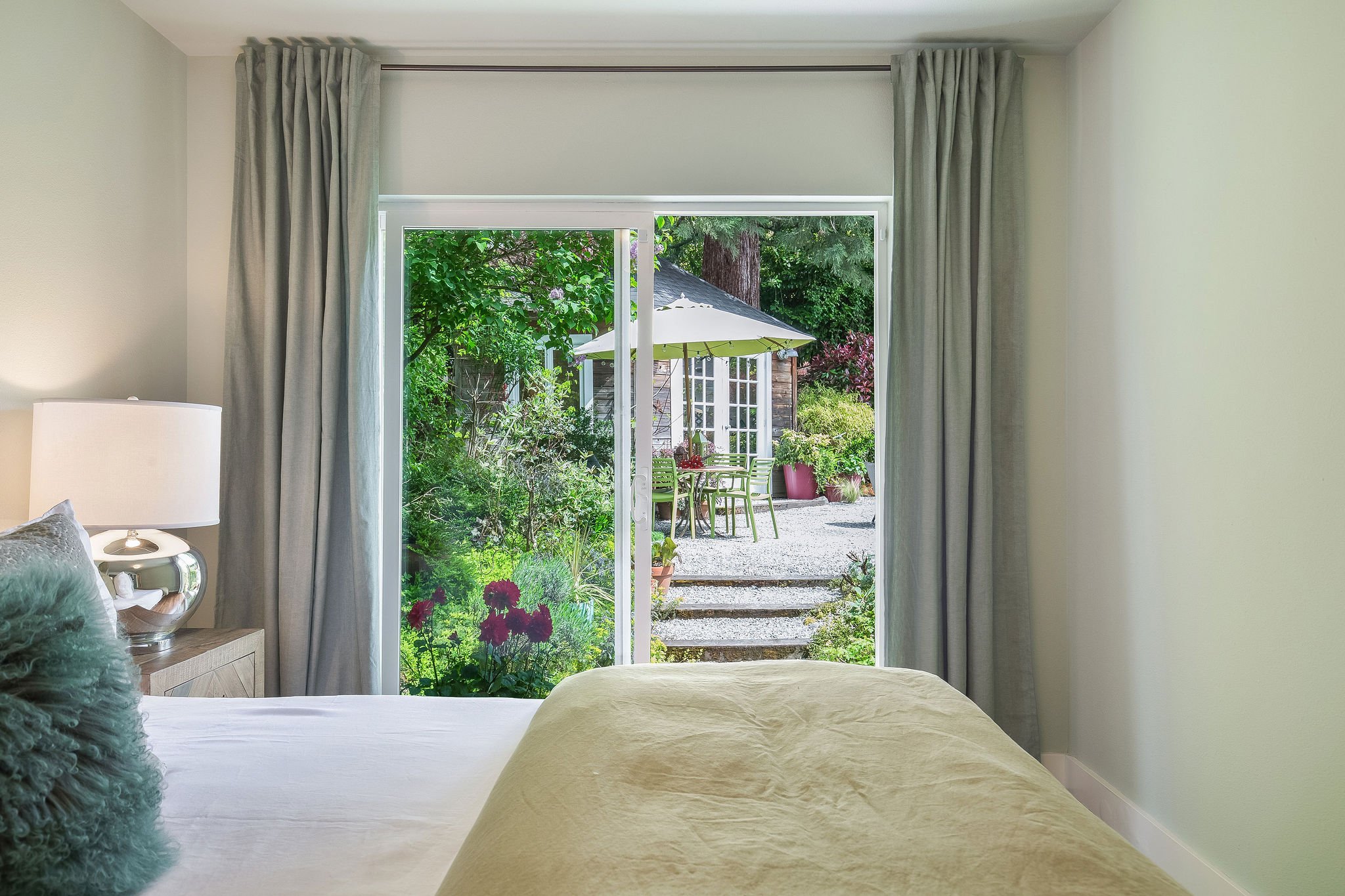  image description: interior of bedroom with carpet,  queen bed and sliding glass door 