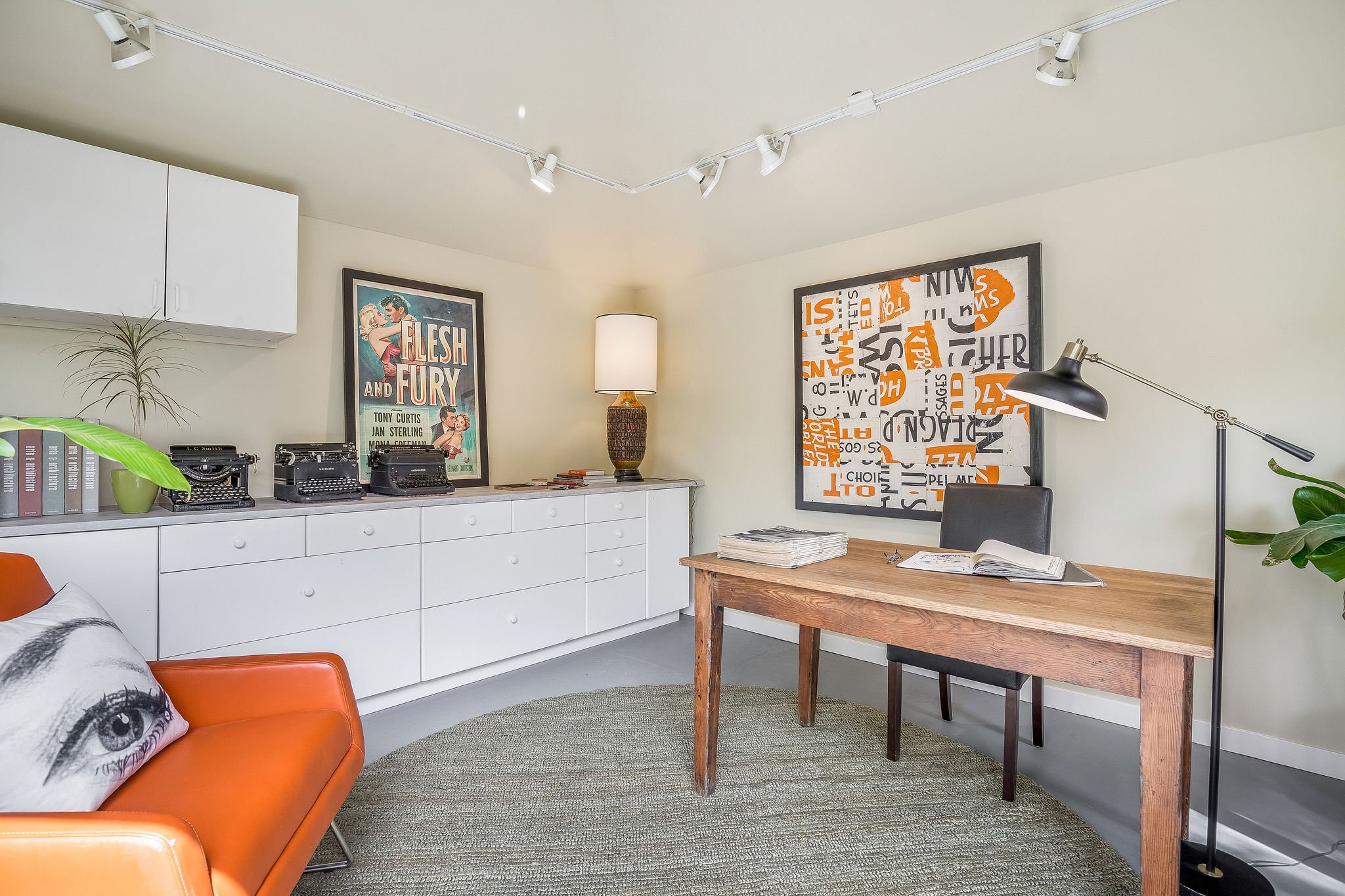  image description: interior of office with long dresser, arm chair, desk and chair, and carpet 