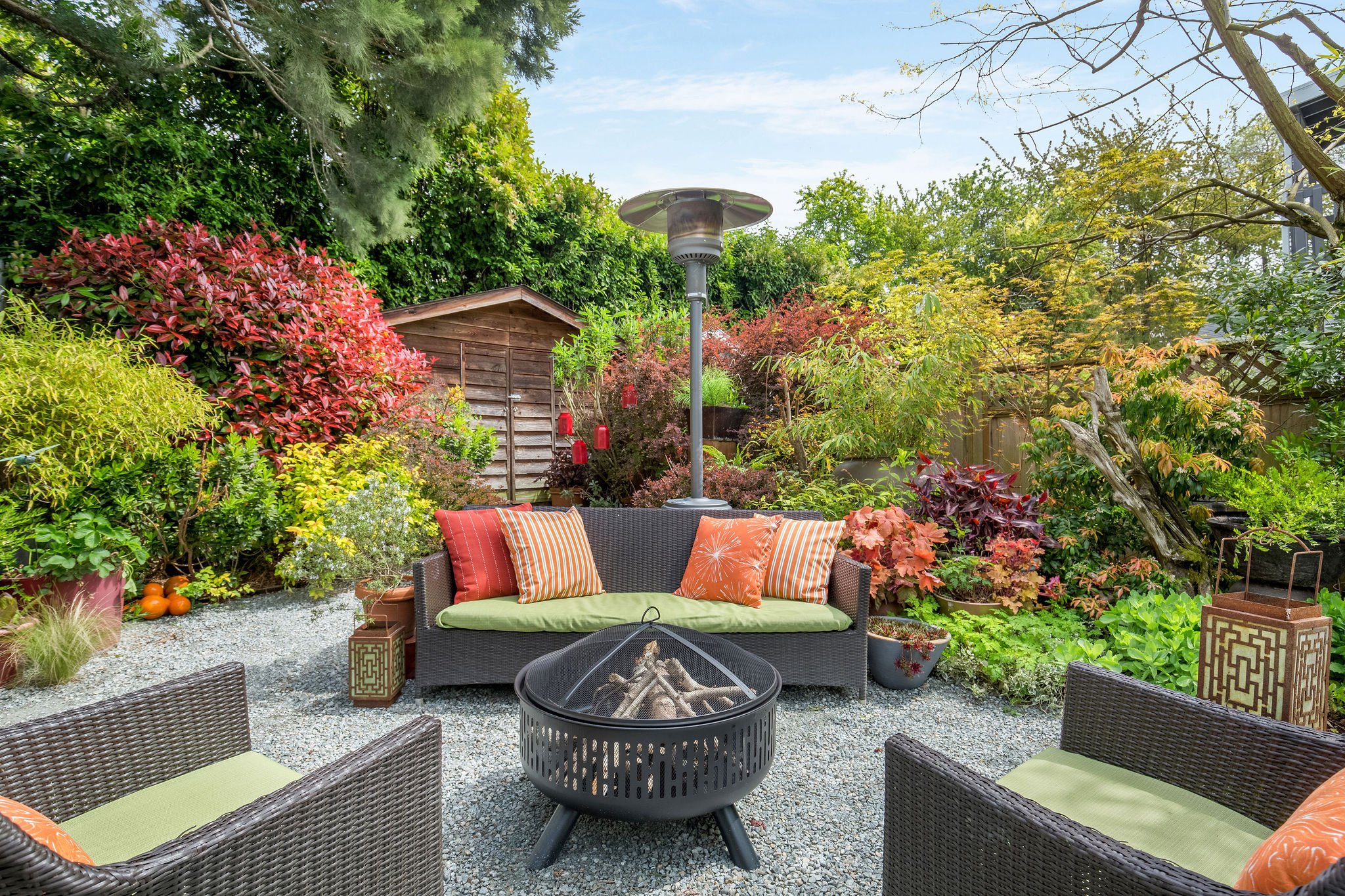  image description: exterior of patio with fire pit and patio furniture 