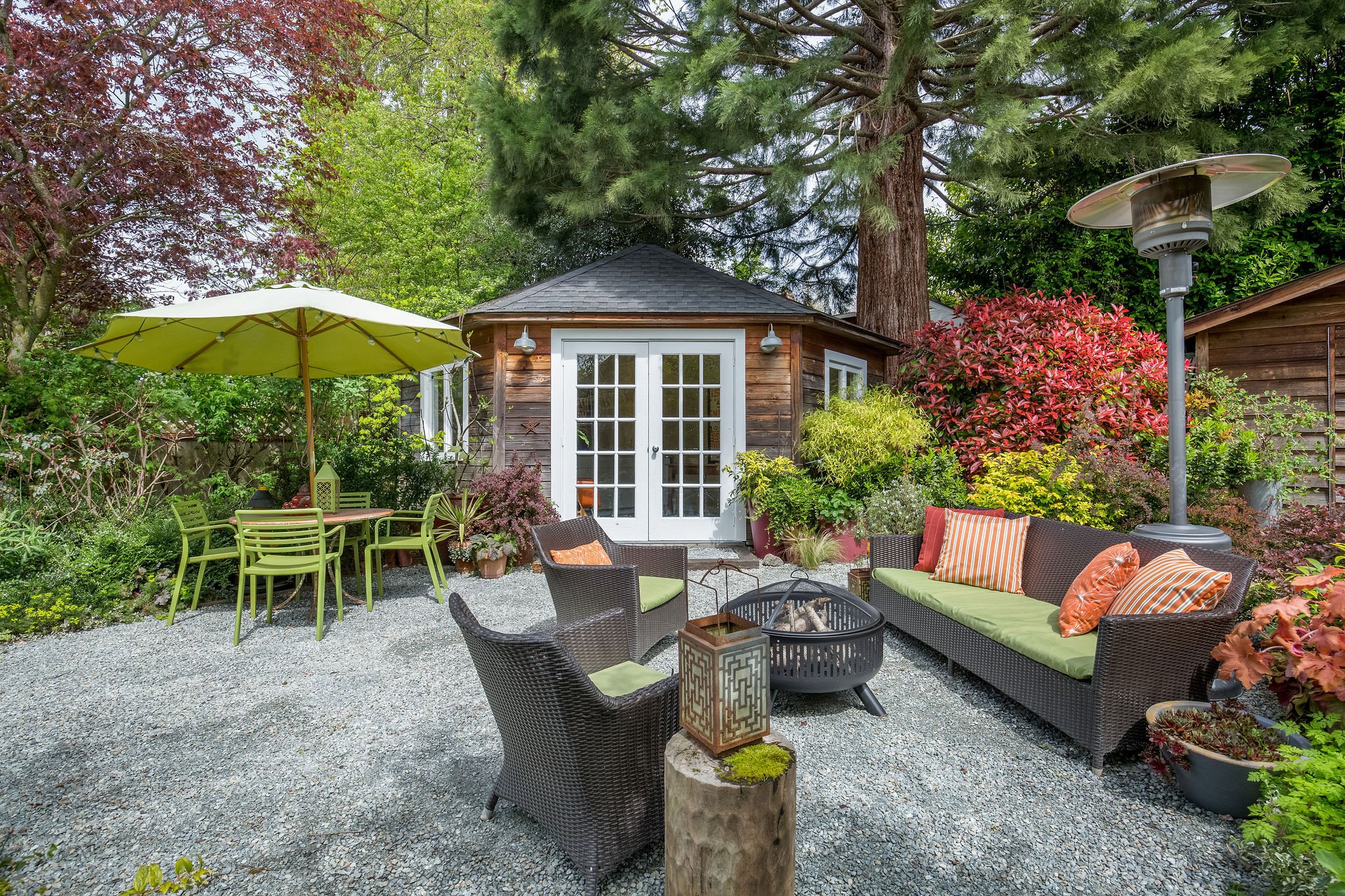  image description: exterior of patio with fire pit, patio furniture and shed 
