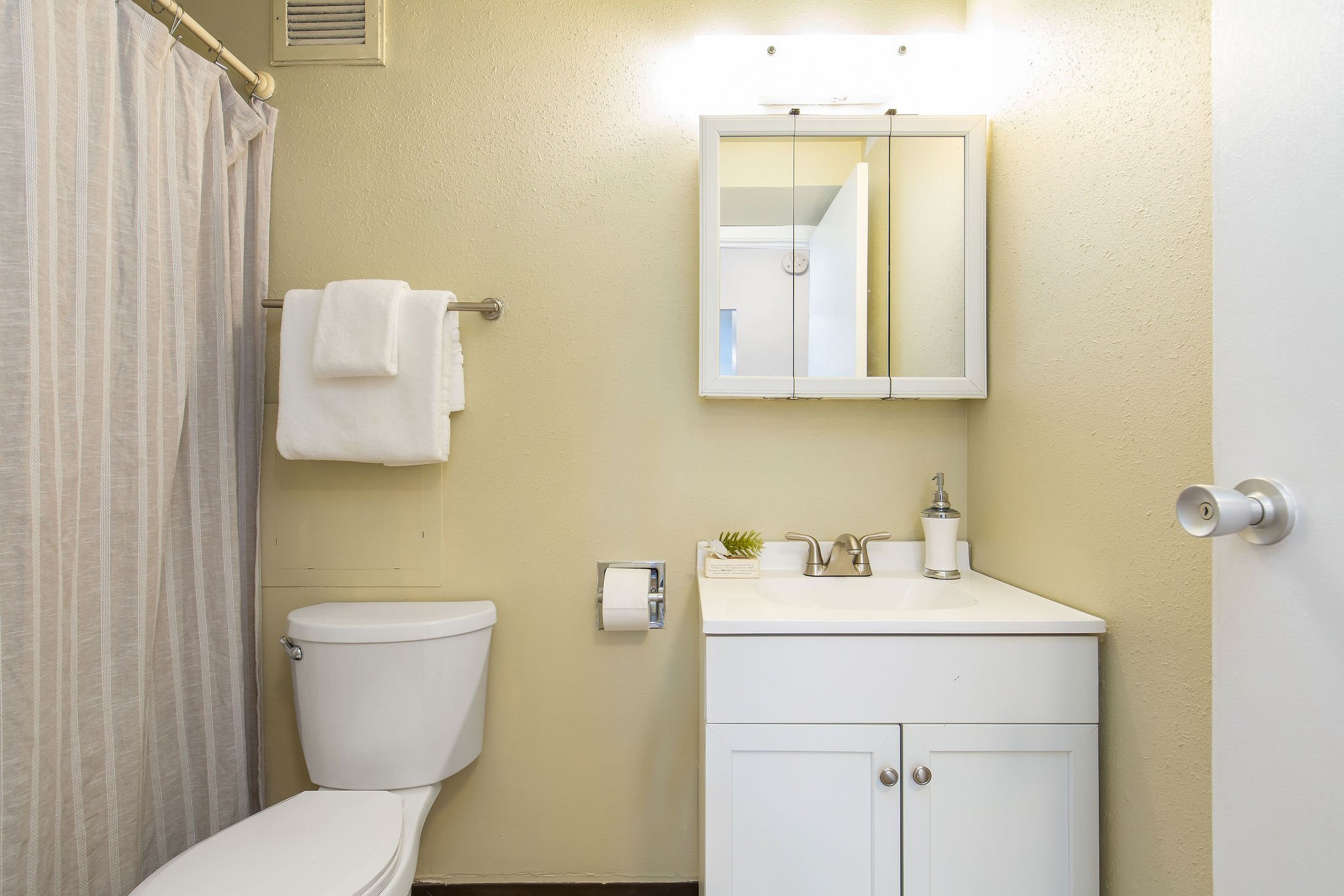  image description: interior of bathroom with bathtub shower combo 