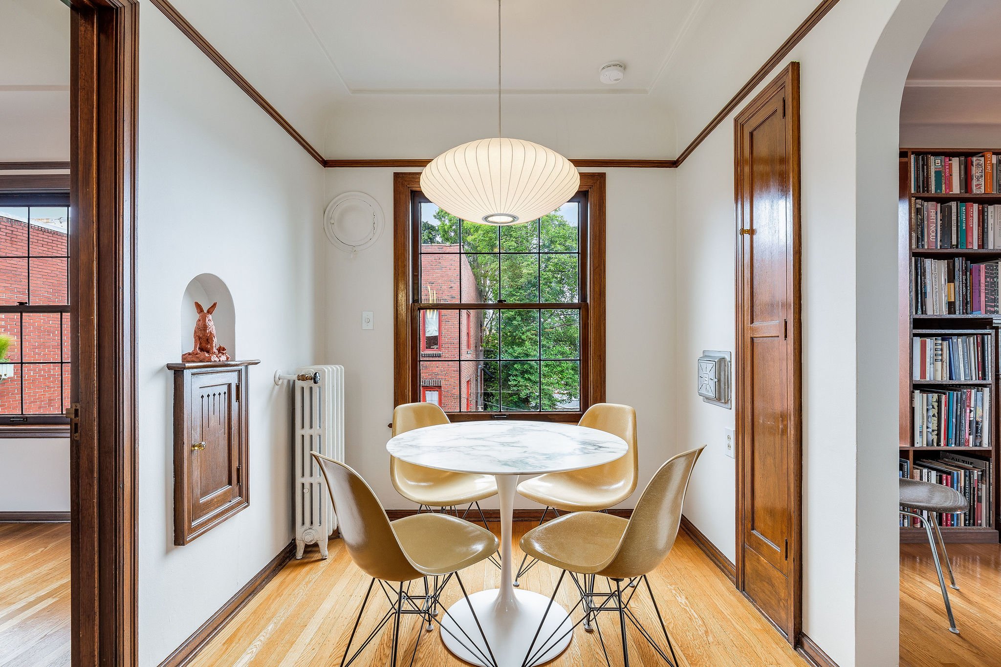 The dining space easily sits 4 and looks north out to a territorial view. Nelson Saucer Bubble Lamp stays with the home. Eames chairs and Saarinen table negotiable. 