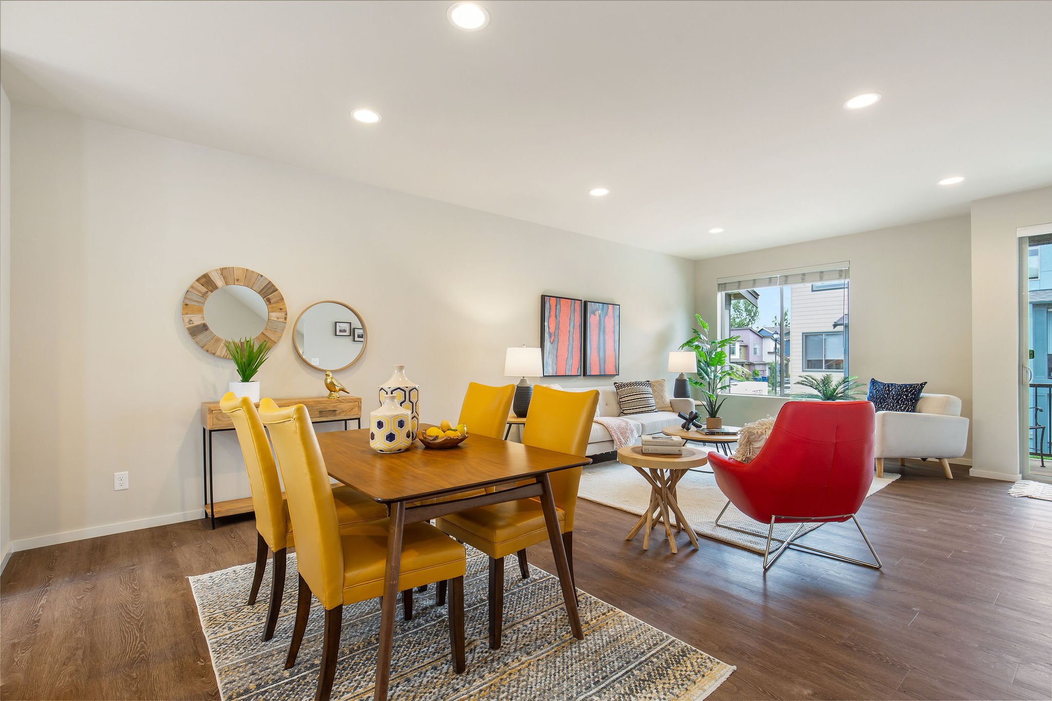  image description: interior of dining room with yellow dining set with view of living room 