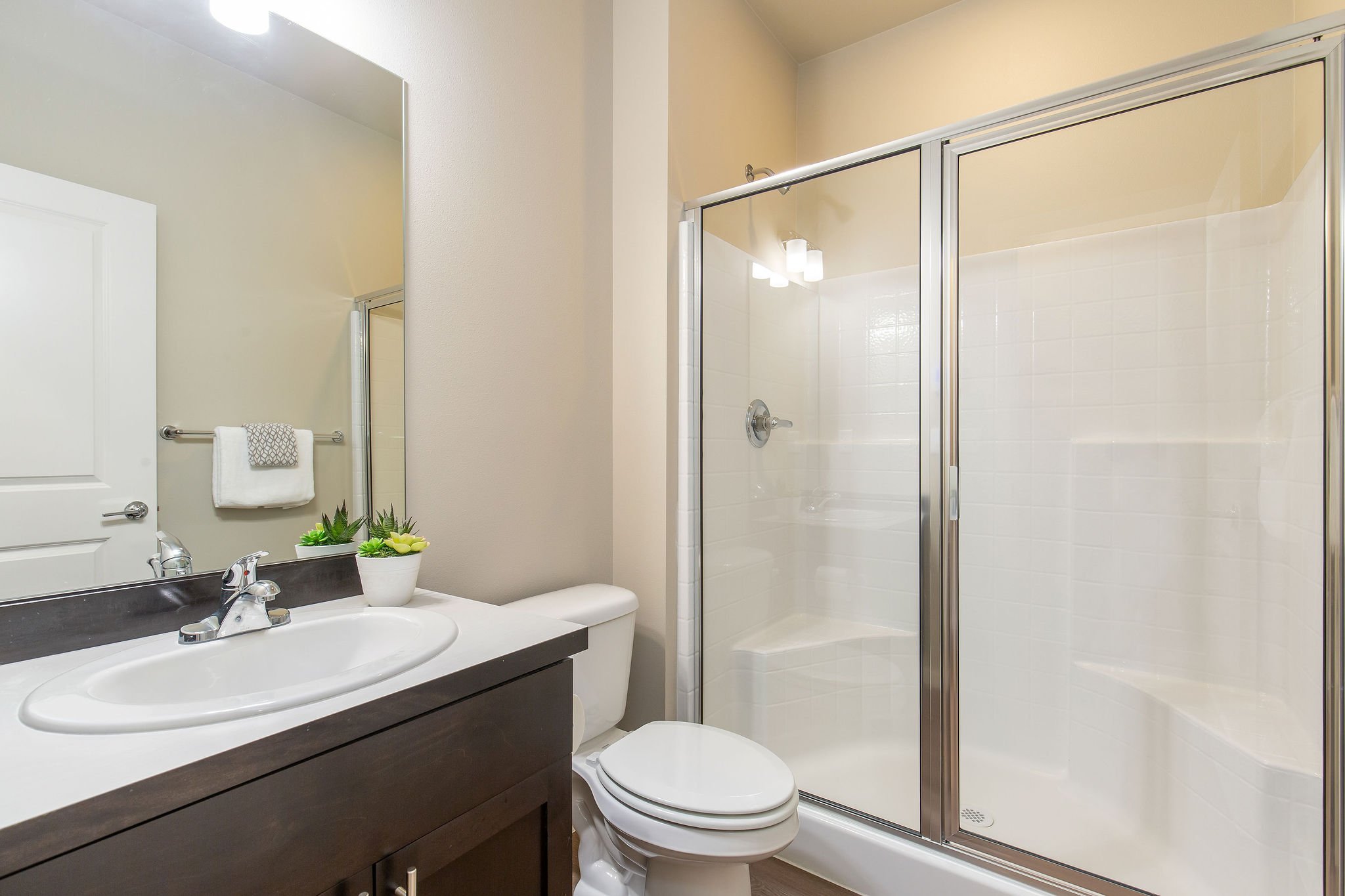  image description: interior of master bathroom with 2 sinks and walk in shower 