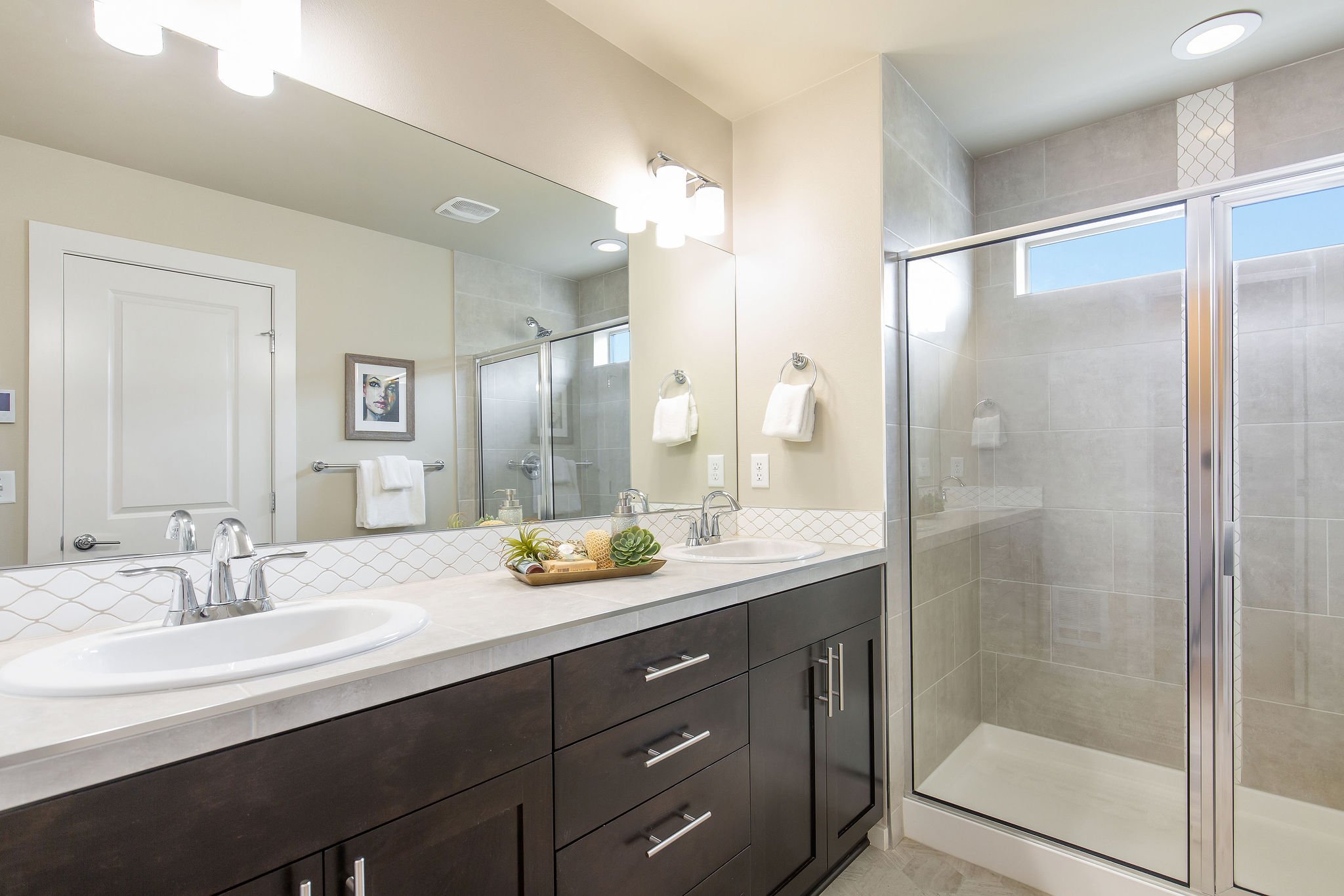  image description: interior of master bathroom with 2 sinks and large walk in shower 