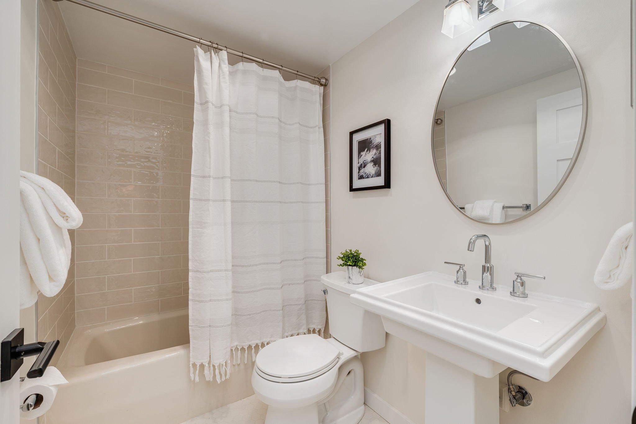  view of all white bathroom with bathtub shower combo 