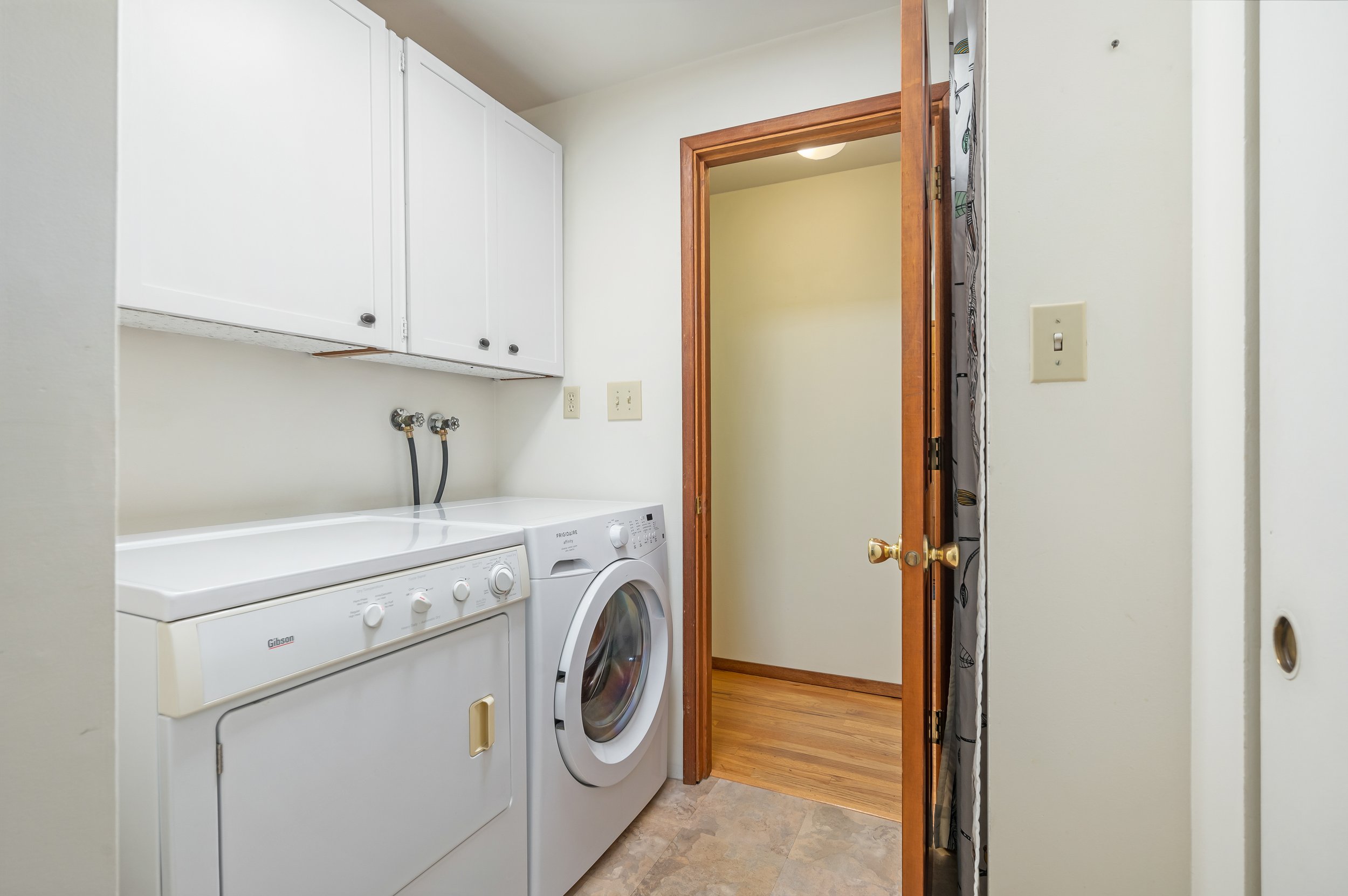  interior of laundry room with washer and dryer and door to yard 