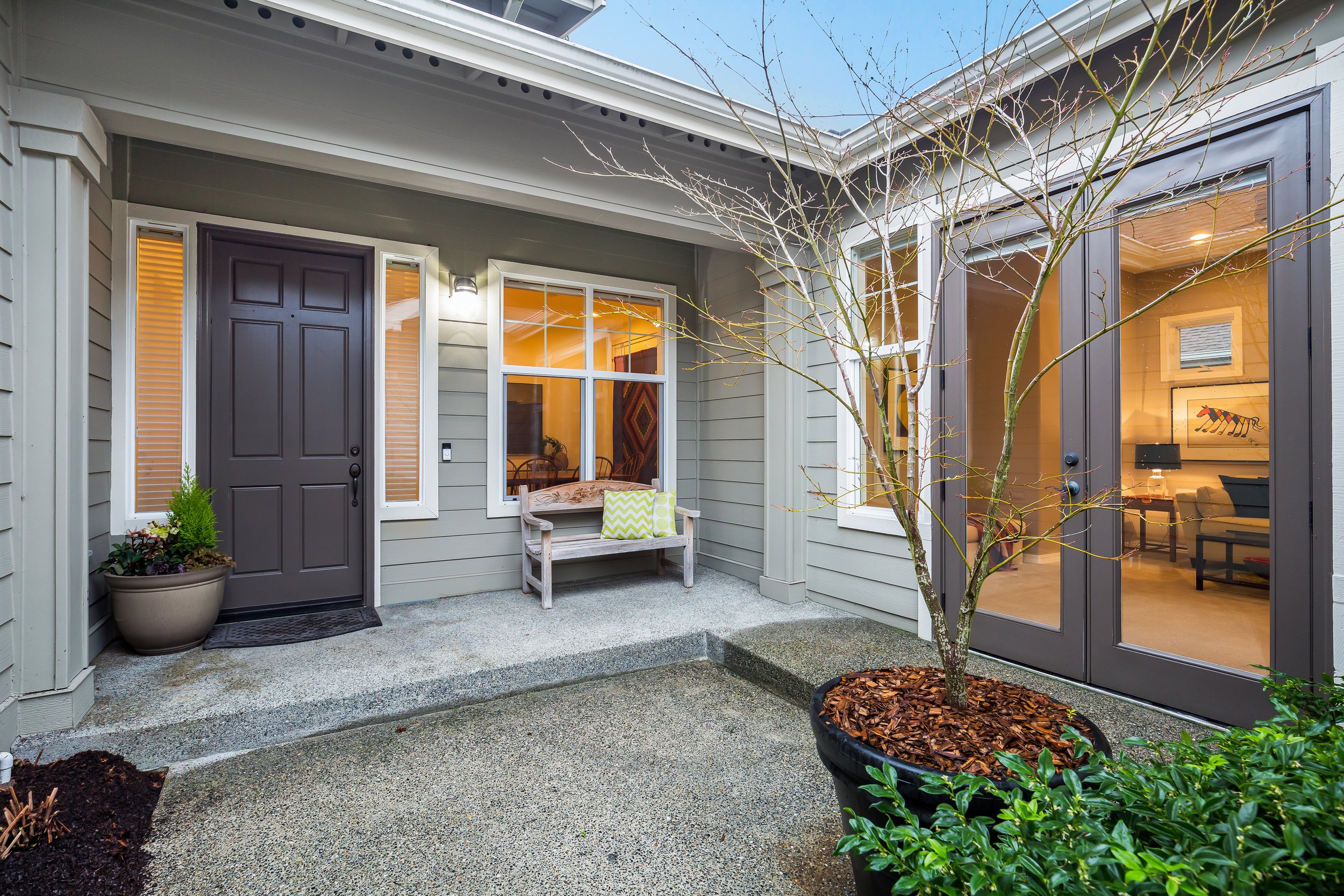  view of front porch with plants and french doors 