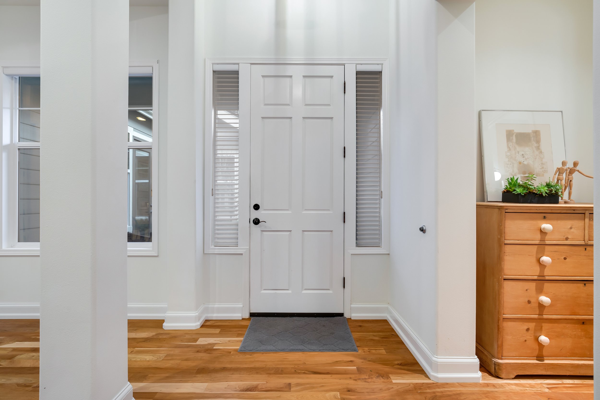  interior of entryway with hardwood floors and windows 