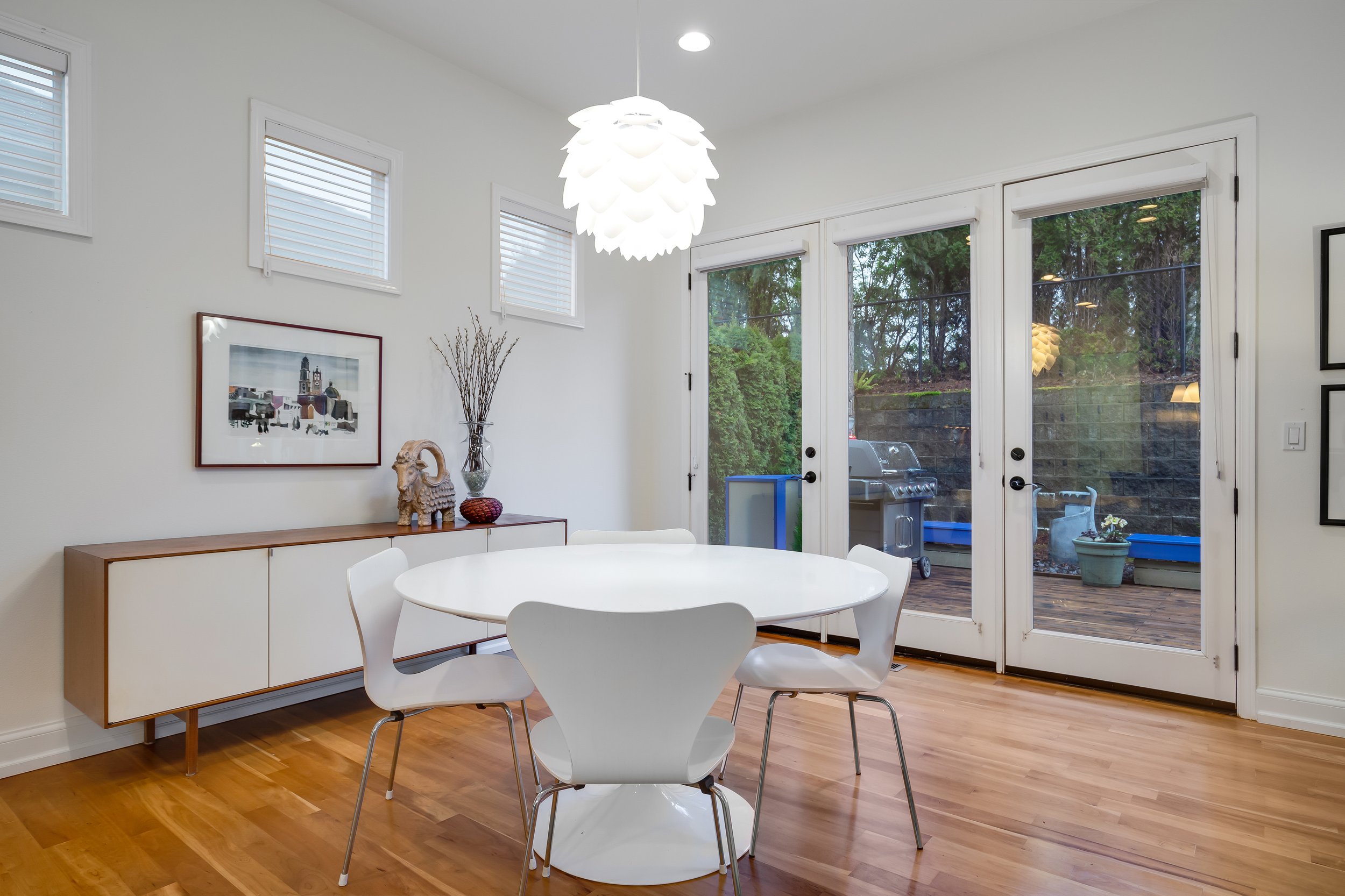  interior of dining room  with hardwood floors, dining table, and french doors 