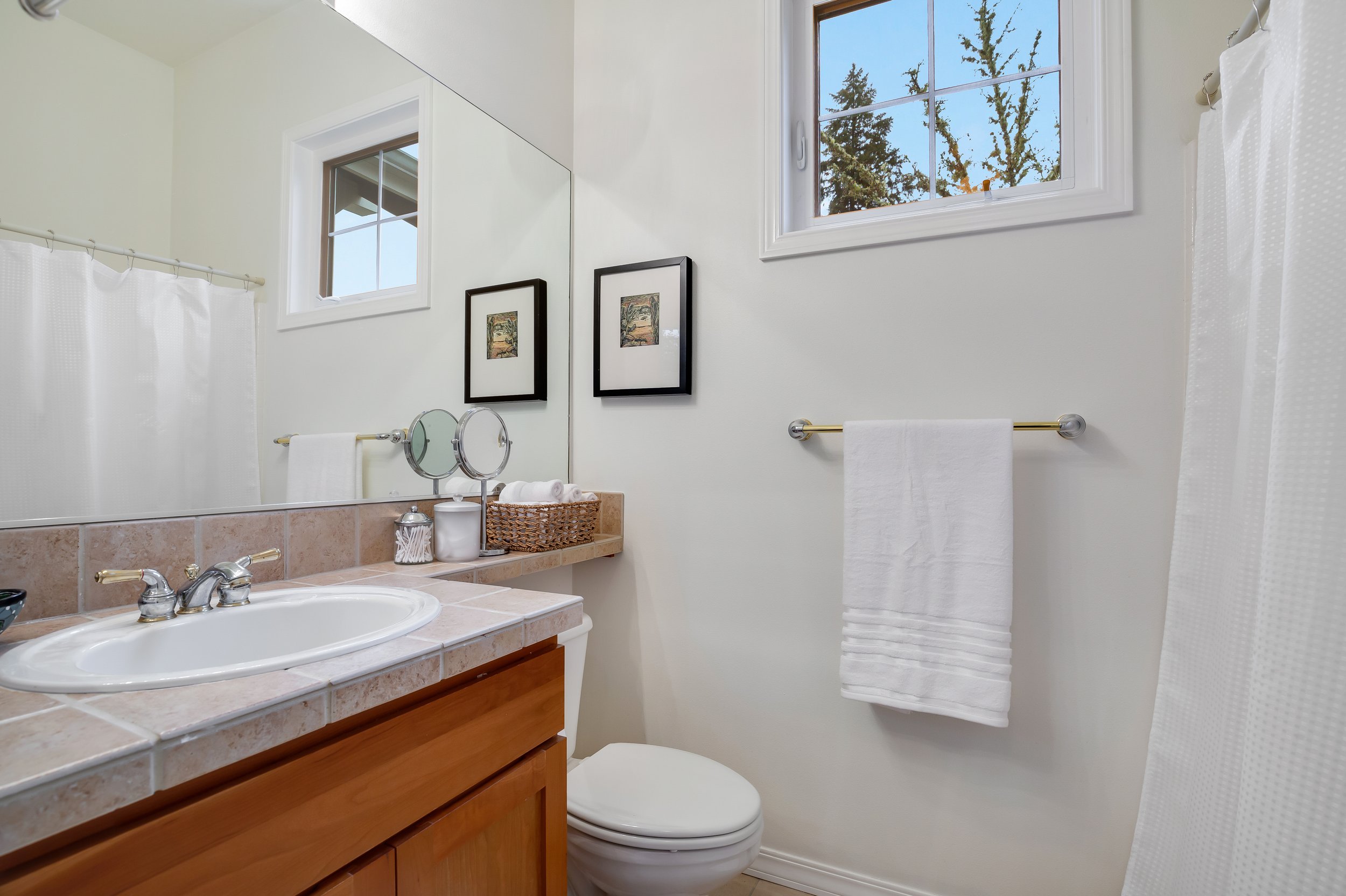  interior of bathroom with window and bathtub and shower combination 