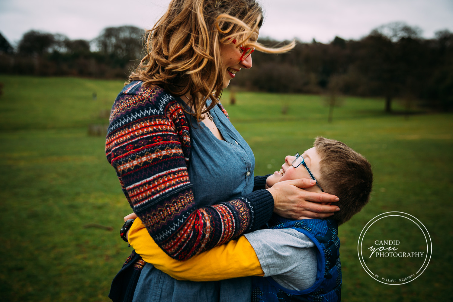 mum holds son's face and looks on with love and son reflects expression of love 