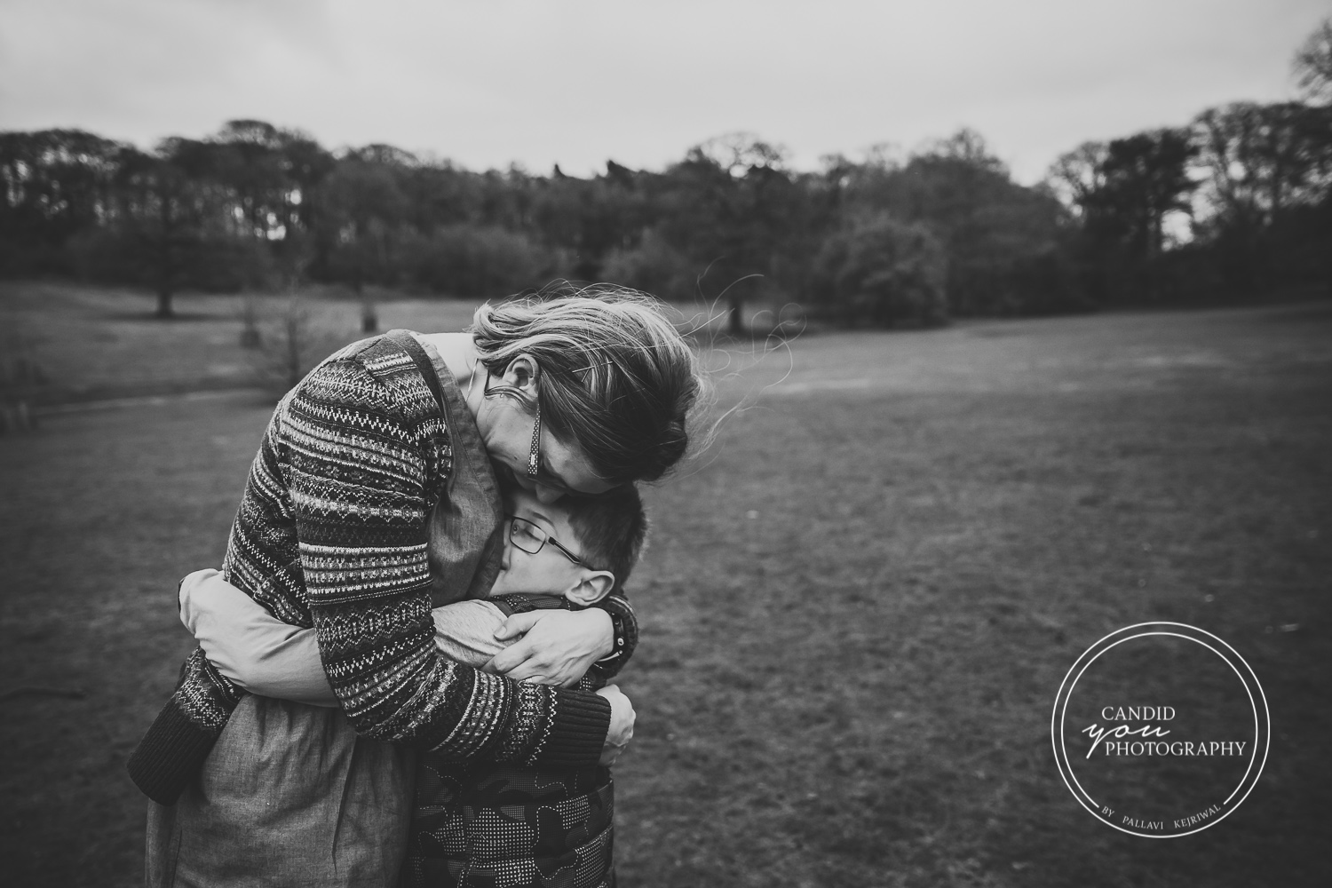 Harborne mum bends down to hug son black and white photography