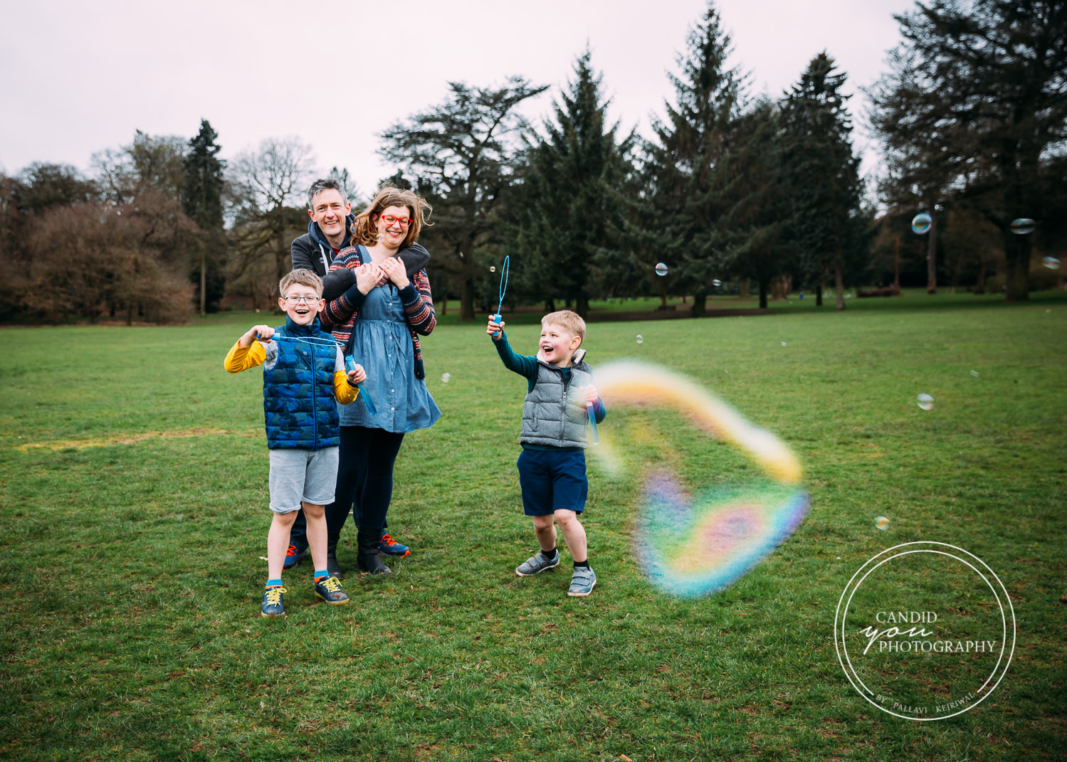 Harborne Family with two boys joyously blowing bubbles in park