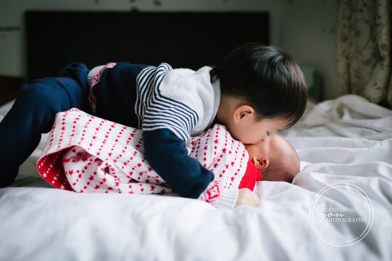 Birmingham UK Asian brother kisses newborn baby sister sweetly