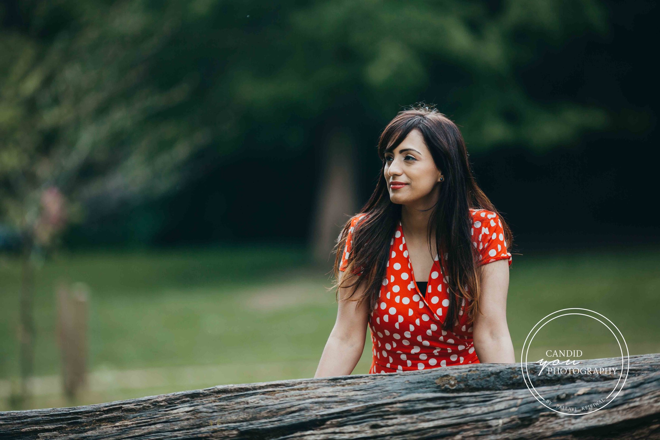 Beautiful woman in orange polka dot dress in park