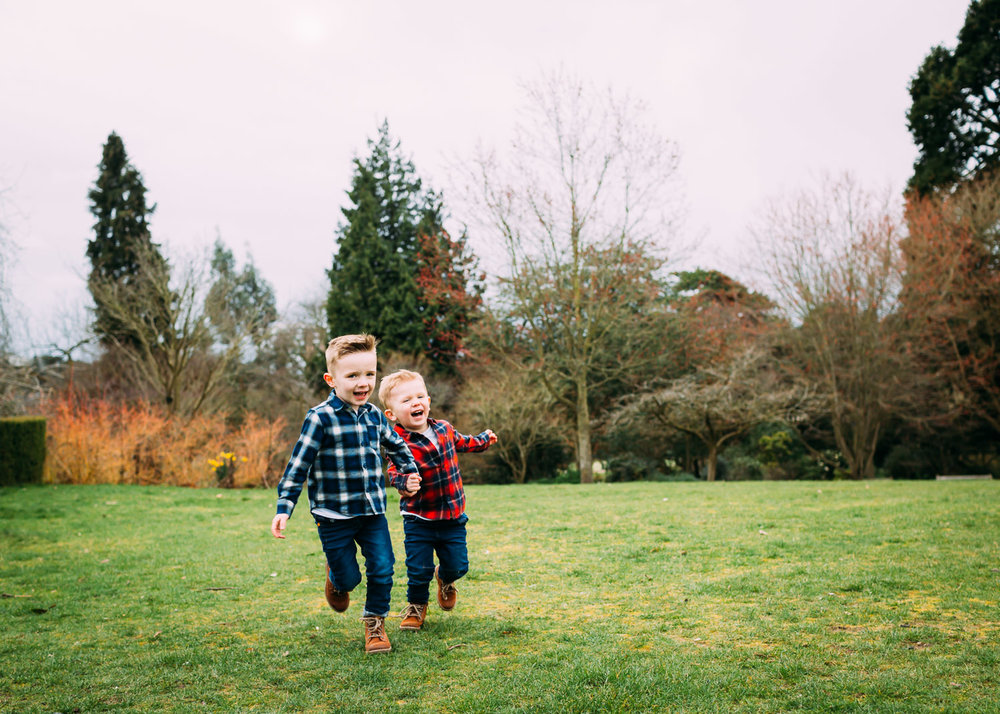 two brothers under 5s running happily holding hands