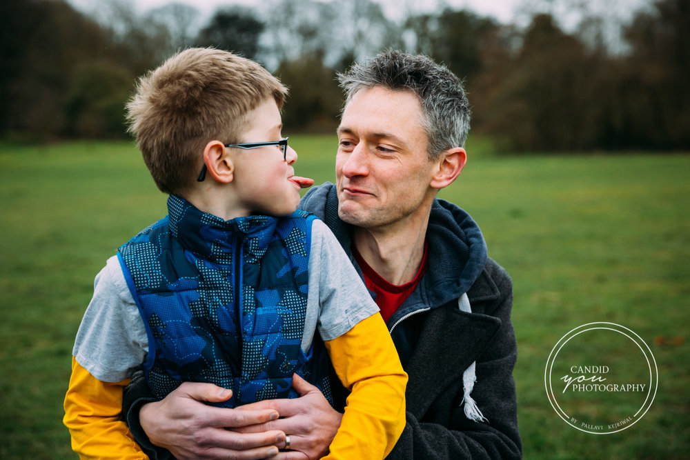 Boy making face at father and showing dad his tongue